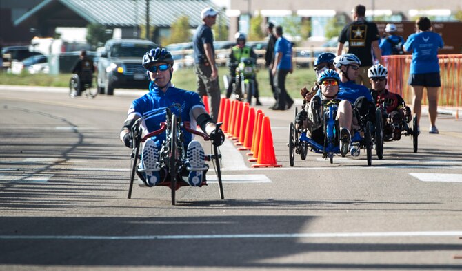 Former Senior Airman Jeremiah Means crosses the finish line at the Warrior Games cycling event Sept. 29, 2014, at Fort Carson, Colo. Means competed in the hand-cycling heat taking eighth place in his category. (U.S.  Air Force photo/Senior Airman Jette Carr)