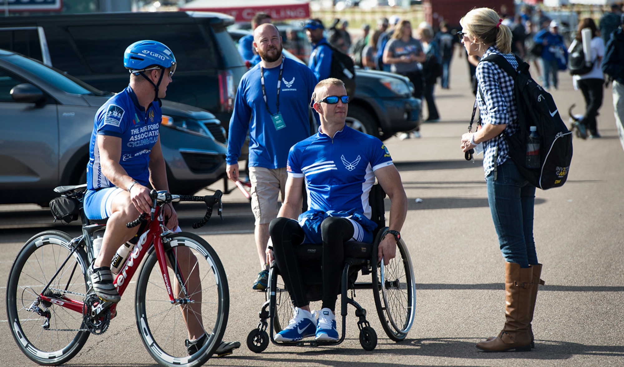 Ashley Means stands by her husband Jeremiah as they talk to other Air Force wounded warriors at the Warrior Games cycling event, Sept. 9, 2014, at Fort Carson, Colo. Ashley is as a caretaker for Jeremiah, a former Senior Airman and wounded warrior. (U.S. Air Force photo/Senior Airman Jette Carr)