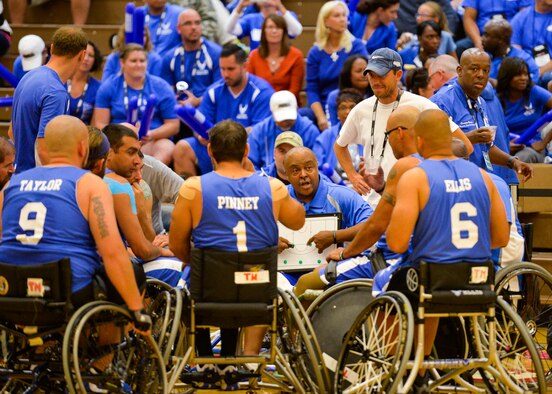 Coach Willie Jackson goes over the next play during an Air Force time out in their game against the Navy at the 2014 Warrior Games Sept. 29, 2014, at the United States Olympic Training Center in Colorado Springs, Colo. The Air Force team lost 38-19 and will play Special Operations in the next round. (U.S Air Force photo/Staff Sgt. Devon Suits) 