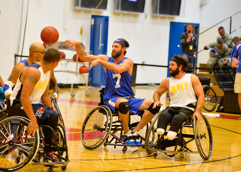 Retired Senior Airman Ryan Gallo makes a pass during the Air Force wheelchair basketball game against the Navy at the 2014 Warrior Games Sept. 29, 2014, at the United States Olympic Training Center in Colorado Springs, Colo. The Air Force team lost 38-19 and will play Special Operations in the next round. (U.S Air Force photo/Staff Sgt. Devon Suits)  
