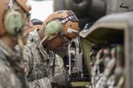 Staff Sgt. Dwight Williams, a member of the ground crew with the 1-130th Attack Reconnaissance Battalion, inspects the forward avionics bay on an Apache Helicopter during a training mission at Fort Bragg, N.C., on Sept. 23, 2014. The 1-130th ARB supported a joint training exercise intended to validate the 14th Air Support Operations Squadron and the 3rd Brigade Combat Team. 