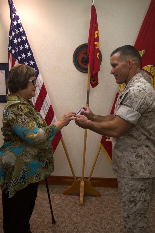 Myrna Nepomuceno, financial management analyst with 12th Marine Corps District, retires after 27 years of faithful service at 12MCD headquarters, Sept. 30, 2014. Nepomuceno was awarded a Certificate of Commendation and a Certificate of Appreciation for her services with the comptroller office at 12MCD since 2002. (U.S. Marine Corps photo by Sgt. Rebecca Eller/ Released)