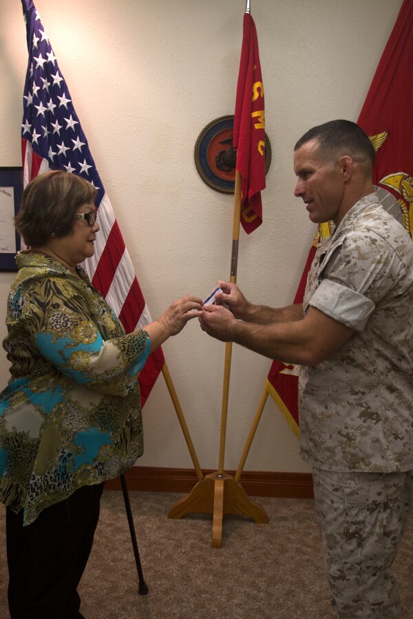 Myrna Nepomuceno, financial management analyst with 12th Marine Corps District, retires after 27 years of faithful service at 12MCD headquarters, Sept. 30, 2014. Nepomuceno was awarded a Certificate of Commendation and a Certificate of Appreciation for her services with the comptroller office at 12MCD since 2002. (U.S. Marine Corps photo by Sgt. Rebecca Eller/ Released)