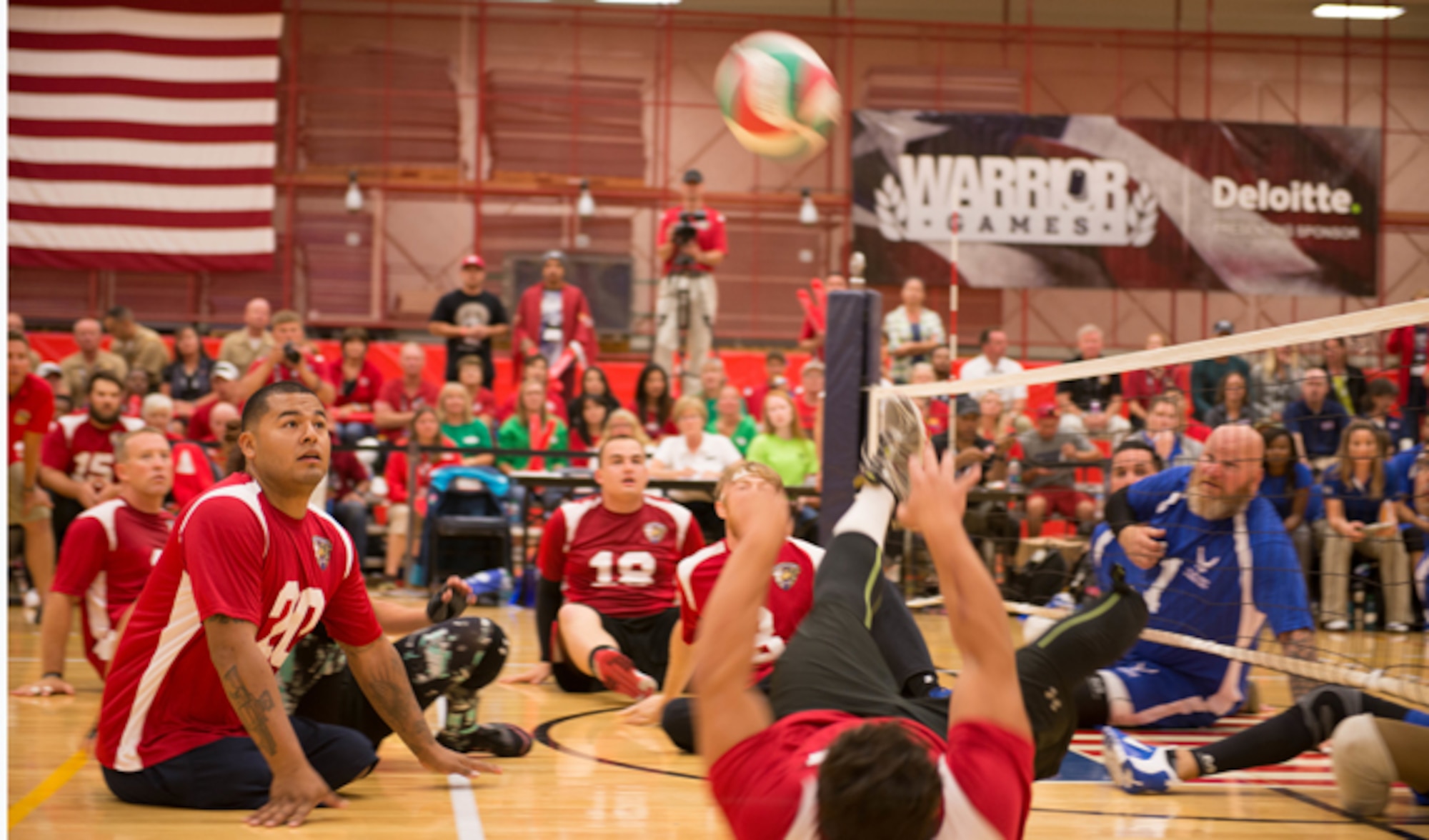 Eric Rodriguez (bottom right), from the Marine Corps volleyball team, tips the ball to teammate Jorge Salazar (middle left) during the teams' volleyball game against Air Force Sept. 29, 2014, at the Warrior Games in Colorado Springs, Colo. The Marines won the first out of three matches with a final of 25-23. (U.S. Marine Corps photo/Cpl. Cuong Le)