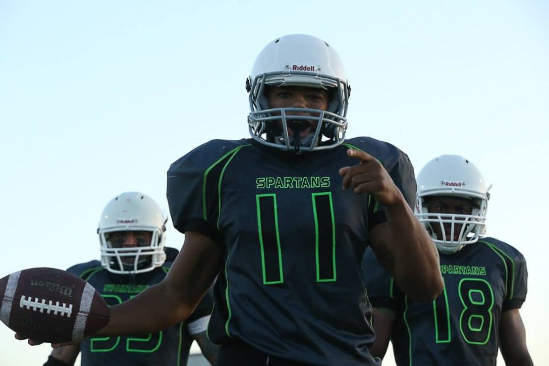 Marine Corps Base Spartans' Mycqwan Nubine scores a touchdown against the 1st Marine Logistics Group Beasts during a Commanding General's Cup football game at the Paige Fieldhouse football field, Sept. 29. The Spartans defeated the Beasts with a score of 13-8. (Photo by Cpl. Shaltiel Dominguez)