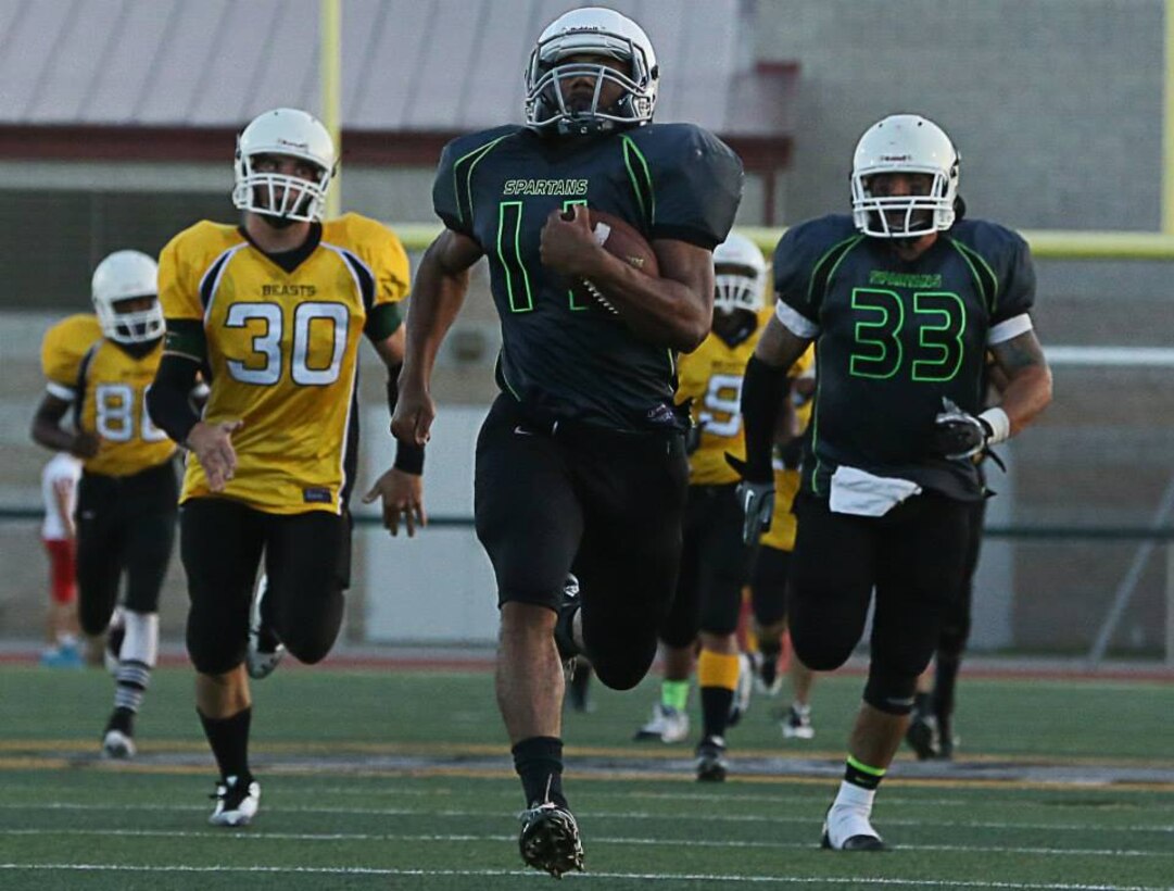 Marine Corps Base Spartans' Mycqwan Nubine scores a touchdown against the 1st Marine Logistics Group Beasts during a Commanding General's Cup football game at the Paige Fieldhouse football field, Sept. 29. The Spartans defeated the Beasts with a score of 13-8. (Photo by Cpl. Shaltiel Dominguez)