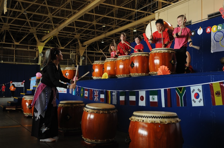 Kazuko Igarashi, instructor of the Dragon-Eagle Taiko drum team, leads her team in a performance during 28th Annual Special Olympics at Misawa Air Base, Japan, Sept. 27, 2014. The drum team was part of the entertainment for the evening for all participants of the Special Olympics and volunteers. (U.S. Air Force photo by Airman Jordyn Rucker)