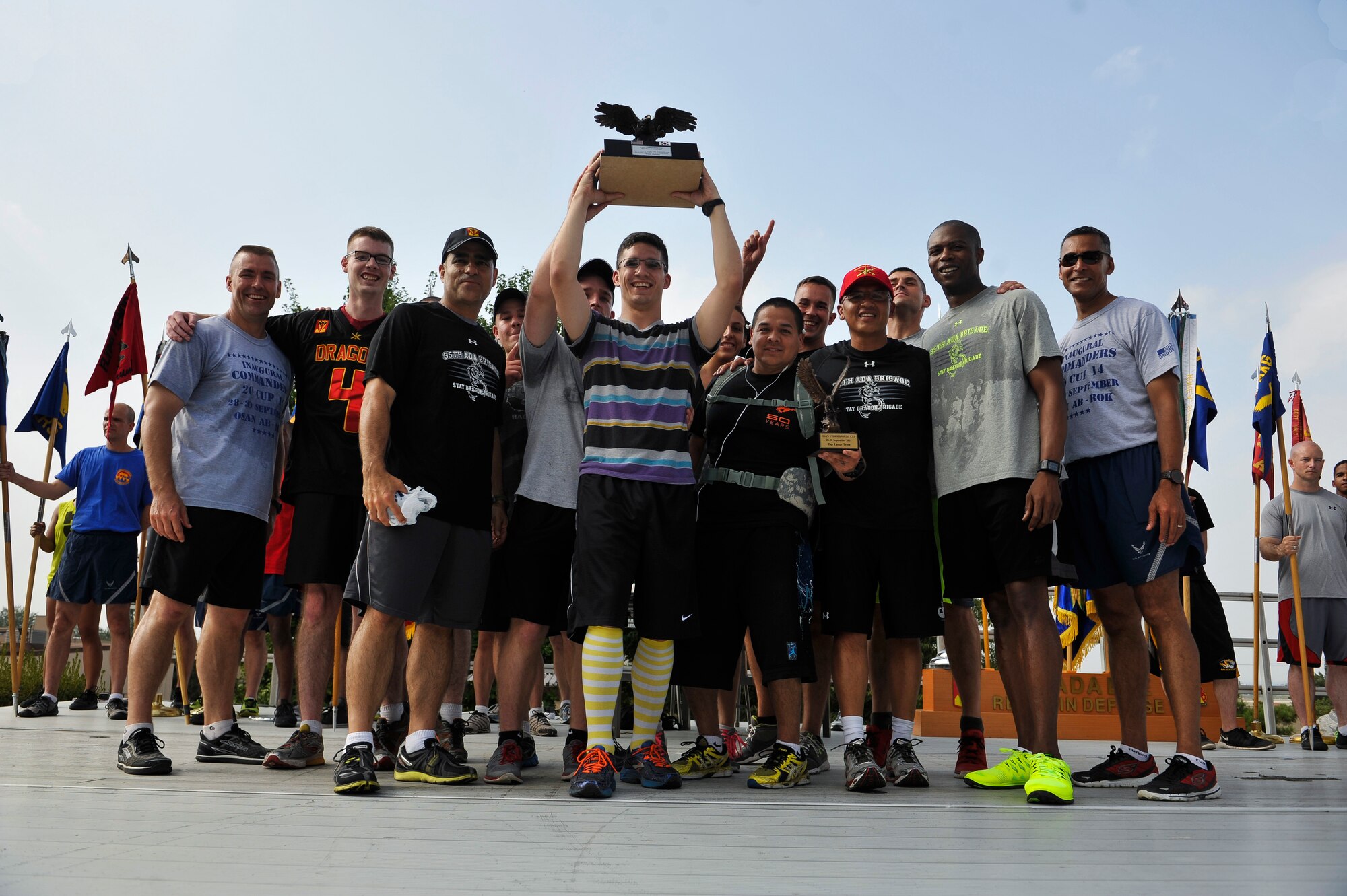Members of the 35th Air Defense Artillery Brigade hold the Osan Cup trophy during the closing ceremony Sept. 30, 2014, at Osan Air Base, Republic of Korea. The ADA won the Osan Cup with a total of 3,993 points. (U.S. Air Force photo by Senior Airman David Owsianka)