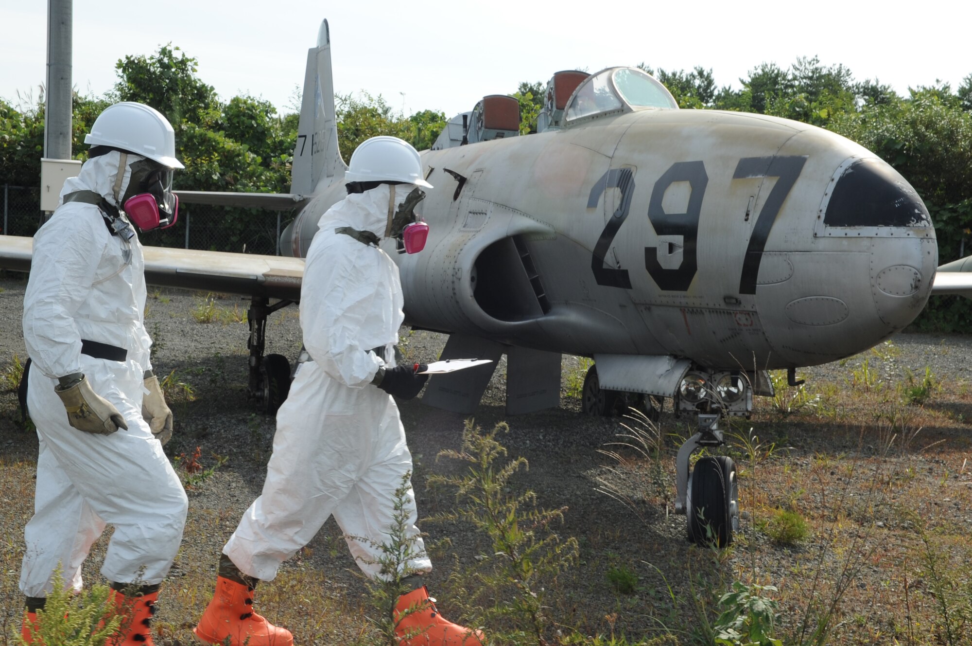 U.S Air Force Staff Sgt. Timothy Amburn and U.S Air Force Airman 1st Class Blake Cyrus, 35th Maintenance Squadron crash recovery team members, inspect the grounds of a simulated aircraft crash site for any hazardous substances during a crash recovery exercise at Misawa Air Base, Japan, Sept. 23, 2014. The purpose of this exercise is to ensure crash recovery team members are prepared to execute in the event of a real-world aircraft recovery. (U.S. Air Force photo by Airman Jordyn Rucker)