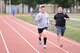 Tech. Sgt. Carlo Salilican, Warrior Run Program coach, sprints alongside a runner during a morning session at Yokota Air Base, Japan, Sept. 19, 2014. Salilican, along with three other coaches, help motivate participants to give 100 percent effort during workout sessions. (U.S. Air Force photo by Staff Sgt. Cody H. Ramirez/Released)