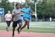 Staff Sgt. Anthony Washington, Warrior Run Program coach, sprints alongside a runner during a morning session at Yokota Air Base, Japan, Sept. 19, 2014. Washington is one of four coaches for the WRP. (U.S. Air Force photo by Staff Sgt. Cody H. Ramirez/Released)