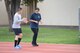 Tech. Sgt. Carlo Salilican, Warrior Run Program coach, explains a running technique to a participant during a session at Yokota Air Base, Japan, Sept. 19, 2014. Salilican has coached the WRP since its conception at Yokota in 2013, the current course being his third iteration. (U.S. Air Force photo by Staff Sgt. Cody H. Ramirez/Released)