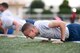 An Airman forces another push-up during a session of the Warrior Run Program at Yokota Air Base, Japan, Sept. 19, 2014. The 9-week program is part of the Healthy Base Initiative and is held once during the fall and spring each year to assist community members wanting to improve their physical fitness. (U.S. Air Force photo by Staff Sgt. Cody H. Ramirez/Released)