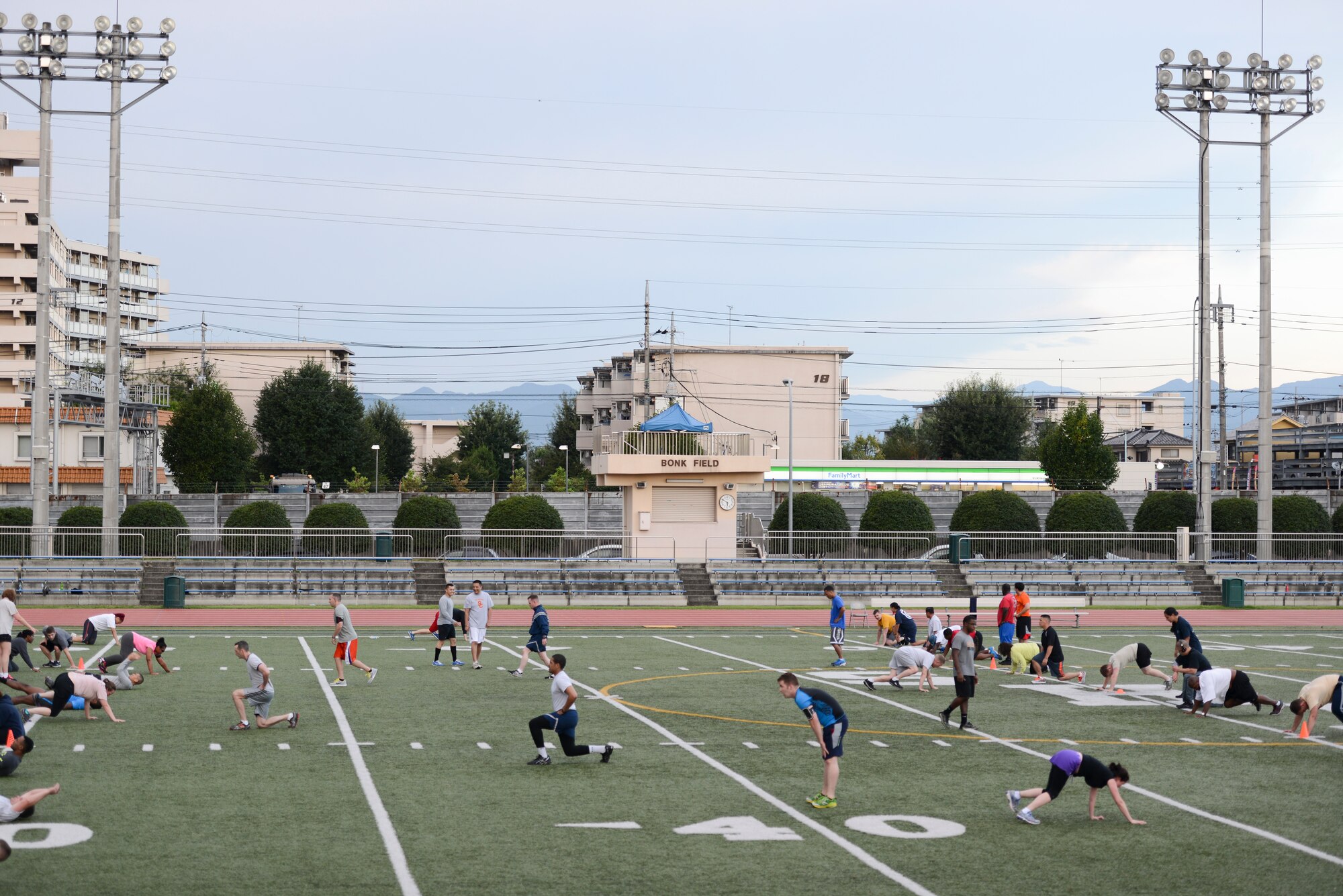 Yokota community members perform circuit training during the Warrior Run Program at Yokota Air Base, Japan, Sept. 19, 2014. The current course has 84 participants utilizing the program to improve their health and wellness. (U.S. Air Force photo by Staff Sgt. Cody H. Ramirez/Released)