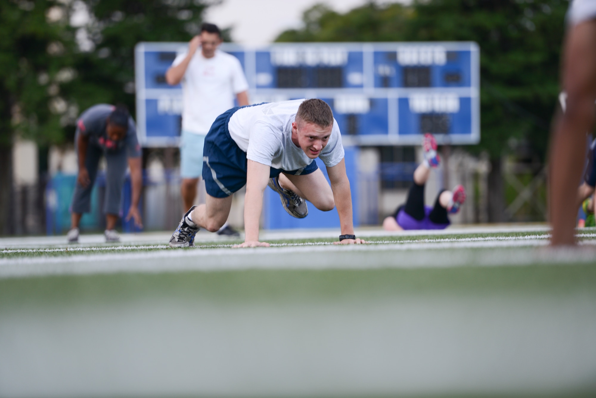 An Airman pushes himself through bear crawls during a morning session of the Warrior Run Program at Yokota Air Base, Japan, Sept. 19, 2014. The program is part of the Healthy Base Initiative and is held semiannually at Yokota to assist service members in improving their physical fitness scores or to improve their overall health and wellness. (U.S. Air Force photo by Staff Sgt. Cody H. Ramirez/Released)