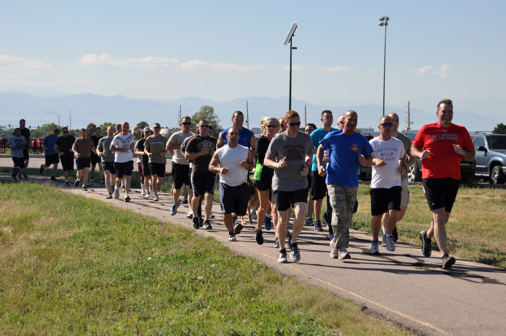 Team Buckley members take off at the beginning of WARFIT Sept. 25, 2014, on Buckley Air Force Base, Colo. The 460th Civil Engineer Squadron hosted the September WARFIT, which consisted of a 5K run and a mud obstacle course. WARFIT is a way for the 460th Space Wing and base partner units to get together and stay physically fit. (U.S. Air Force photo by Tech. Sgt. Robert Hazelett/Released)