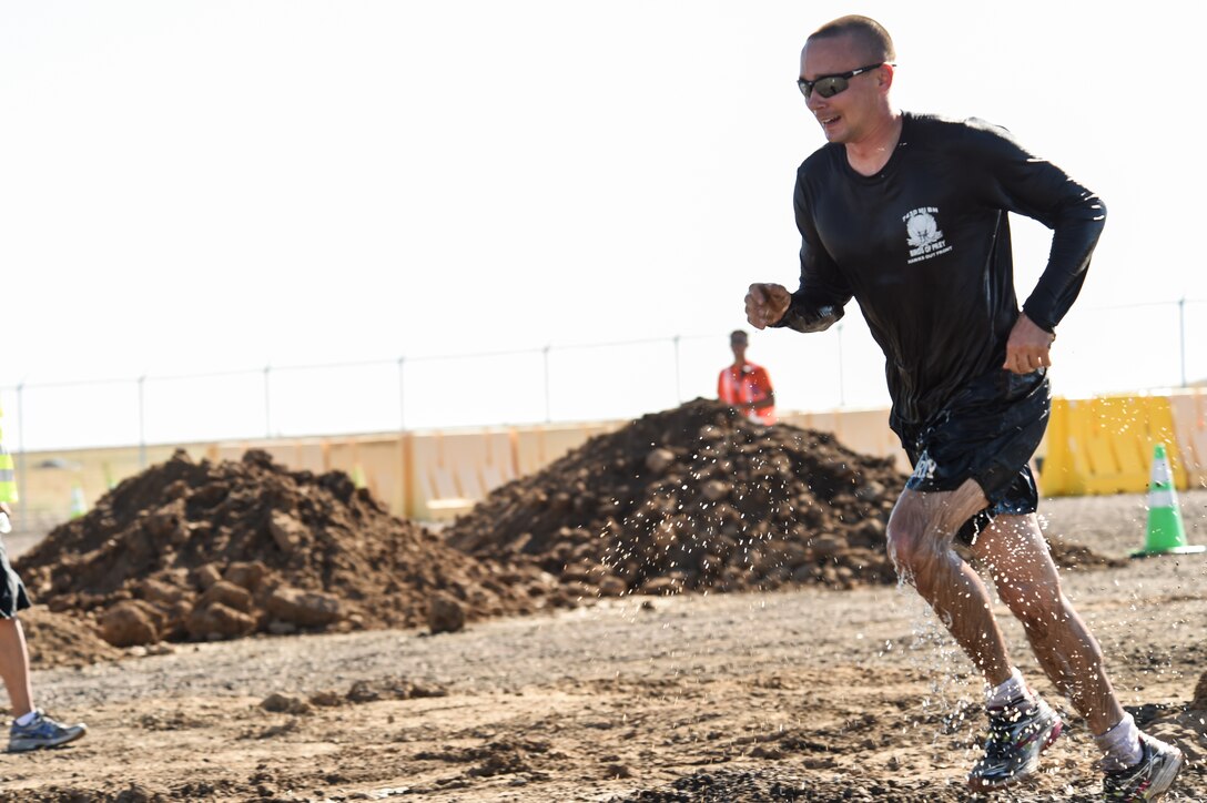 A Team Buckley member takes off running during WARFIT Sept. 25, 2014, on Buckley Air Force Base, Colo. The 460th Civil Engineer Squadron hosted the September WARFIT, which consisted of a 5K run and a mud obstacle course. WARFIT is a way for the 460th Space Wing and base partner units to get together and stay physically fit. (U.S. Air Force photo by Senior Airman Phillip Houk/Released)