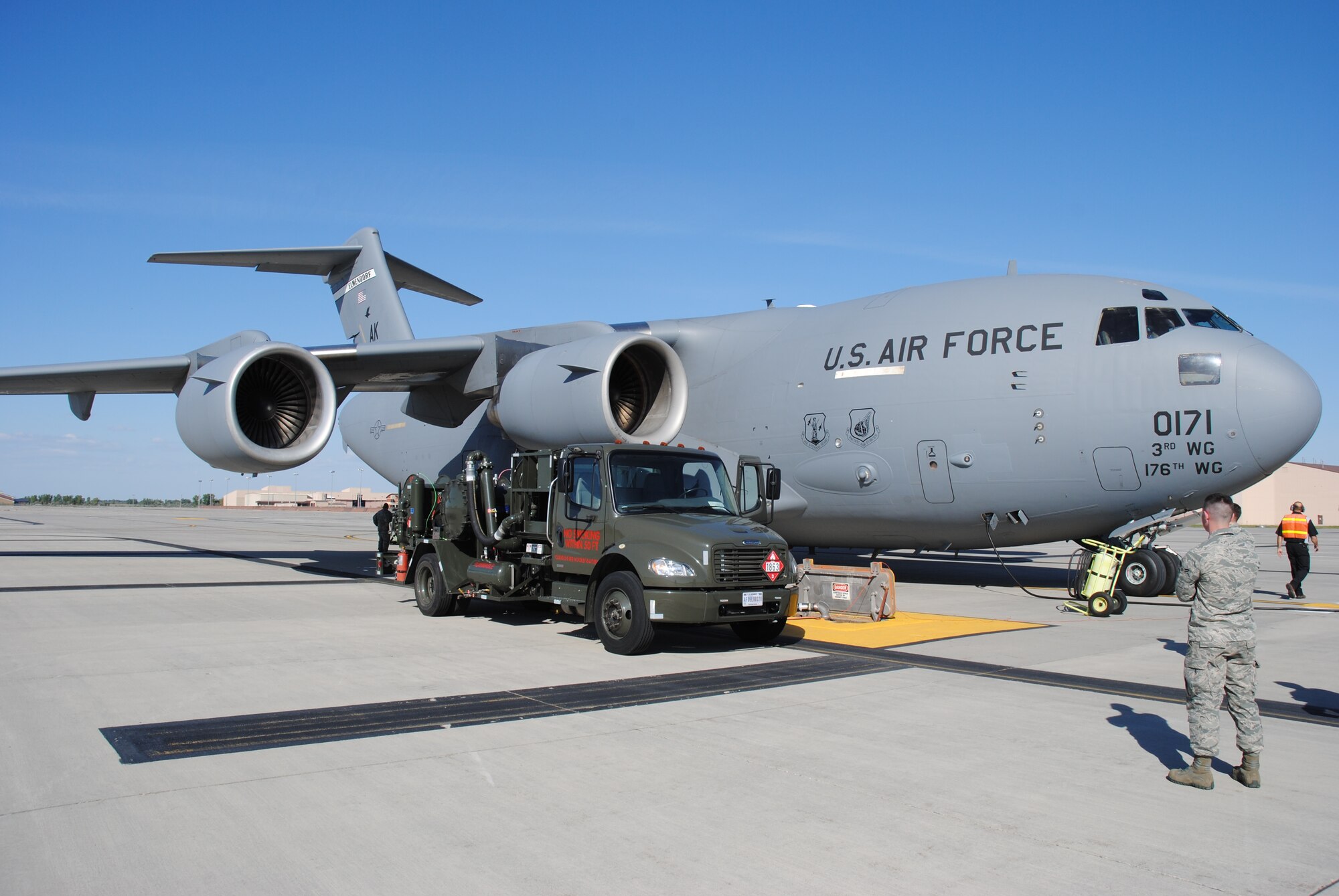 Airmen and Air Force civilian contractors from Grand Forks Air Force Base, N.D., refuel a Boeing C-17 Globemaster III assigned to the 176th Wing, a unit of the Alaska Air National Guard, at Joint Base Elmendorf-Richardson on the base flightline Sept. 16, 2014.  The C-17 transported more than two dozen Marines from Afghanistan to South Carolina.  The return flight of this C-17 was seen as a joint endeavor between Airmen from the Alaska Air National Guard and active-duty Airmen from Grand Forks AFB designed to help Marines from Marine Fighter Attack Squadron 122 to get home after concluding operations in Afghanistan. (U.S. Air Force photo/Staff Sgt. Luis Loza Gutierrez) 