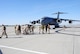 U.S. Marines stretch their legs after the C-17 Globemaster III giving them a lift to their home base of Marine Corps Air Station Beaufort, S.C., makes a pit stop at Grand Forks Air Force Base, N.D., Sept. 16, 2014.  The C-17 transported more than two dozen Marines from Afghanistan to South Carolina. The aircraft is assigned to the 176th Wing, a unit of the Alaska Air National Guard, at Joint Base Elmendorf-Richardson.  (U.S. Air Force photo/Staff Sgt. Luis Loza Gutierrez) 