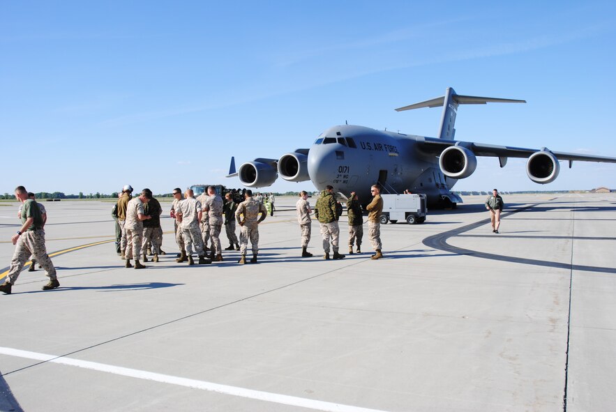U.S. Marines stretch their legs after the C-17 Globemaster III giving them a lift to their home base of Marine Corps Air Station Beaufort, South Carolina, makes a pit stop at Grand Forks Air Force Base, North Dakota, Sept. 16, 2014. The C-17 transported more than two dozen Marines from Afghanistan to South Carolina. The aircraft is assigned to the 176th Wing, a unit of the Alaska Air National Guard, at Joint Base Elmendorf-Richardson. (U.S. Air Force photo/Staff Sgt. Luis Loza Gutierrez) 

