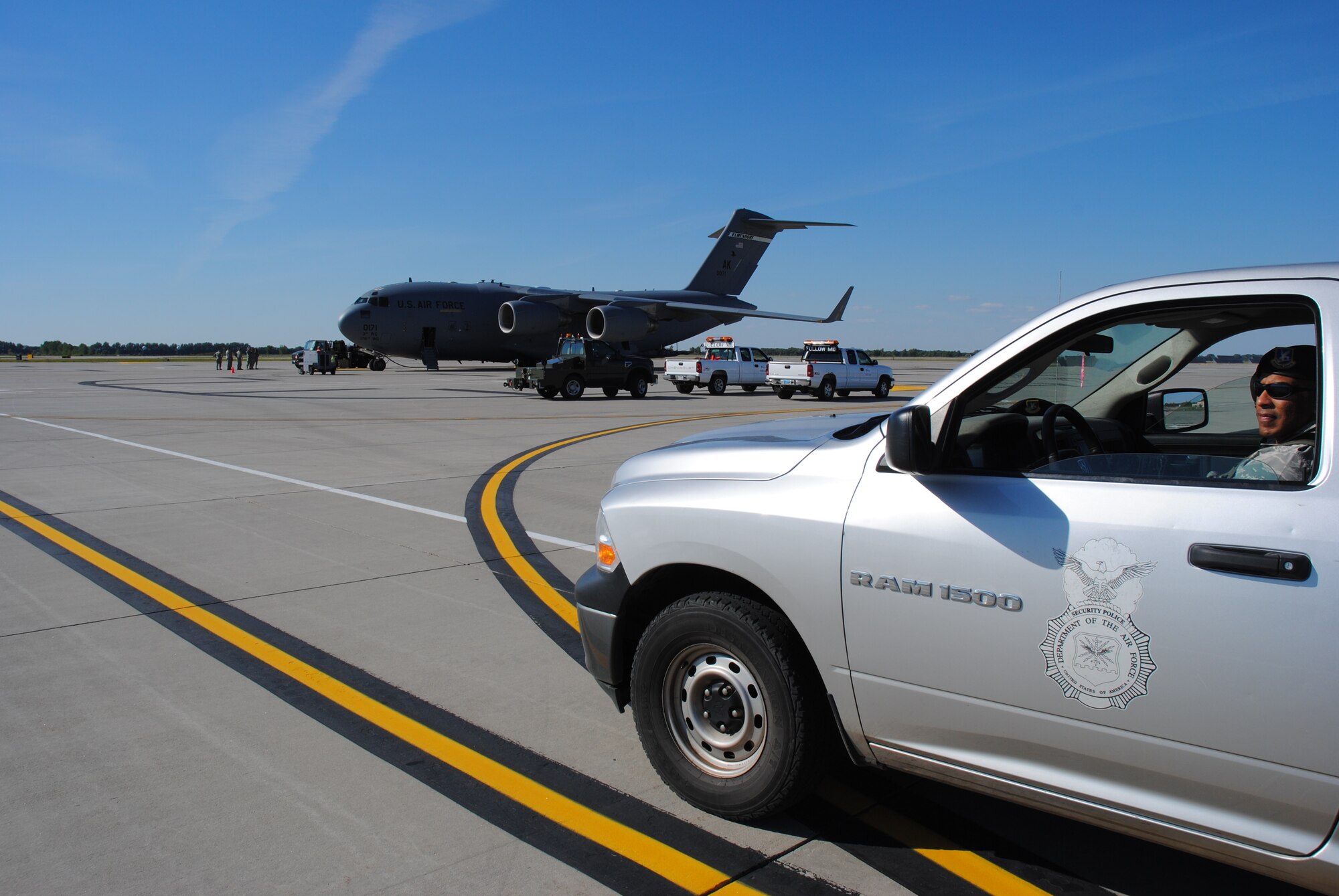 Patrolmen from the 319th Security Forces Squadron at Grand Forks Air Force Base, N.D., position their vehicle to provide security for a C-17 Globemaster III from Joint Base Elmendorf-Richardson, Alaska, Sept. 16, 2014. The Airmen from the 319th SFS protected the aircraft while other Warriors of the North refill their fuel tanks, allowing more than two dozen Marines to continue their journey home to Marine Corps Air Station Beaufort, S.C. U.S. Air Force photo/Staff Sgt. Luis Loza Gutierrez) 