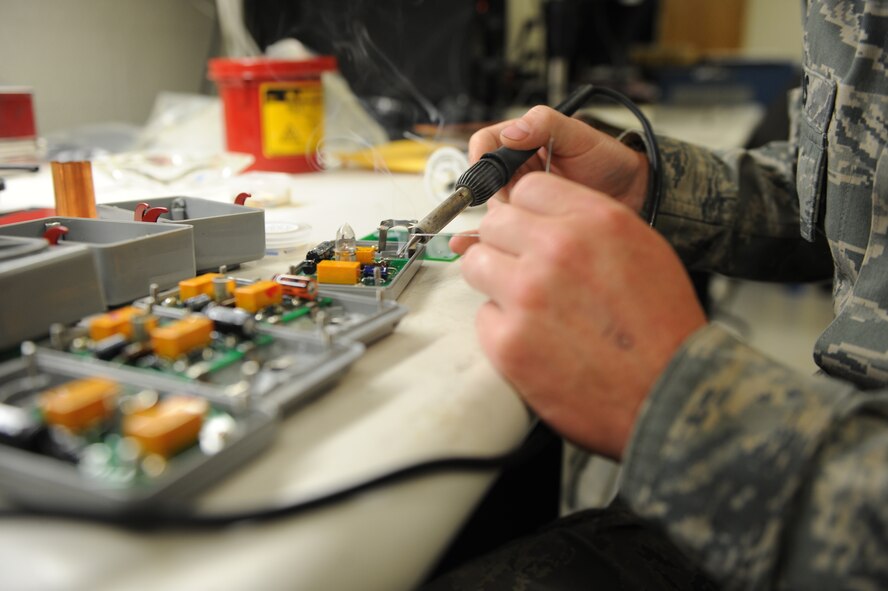 U.S. Air Force Senior Airman Jonathan Beres, 7th Maintenance Group Air Force Repair/Enhancement Program (AFREP) technician, solders a C130J Super Hercules emergency light circuit board at the AFREP shop Aug. 28, 2014, at Dyess Air Force Base, Texas. One of the main areas of focus in the shop is circuit cards, which are costly to replace and often essential to an aircraft’s mission. (U.S. Air Force photo by 2nd Lt. Lauren Linscott/Released)