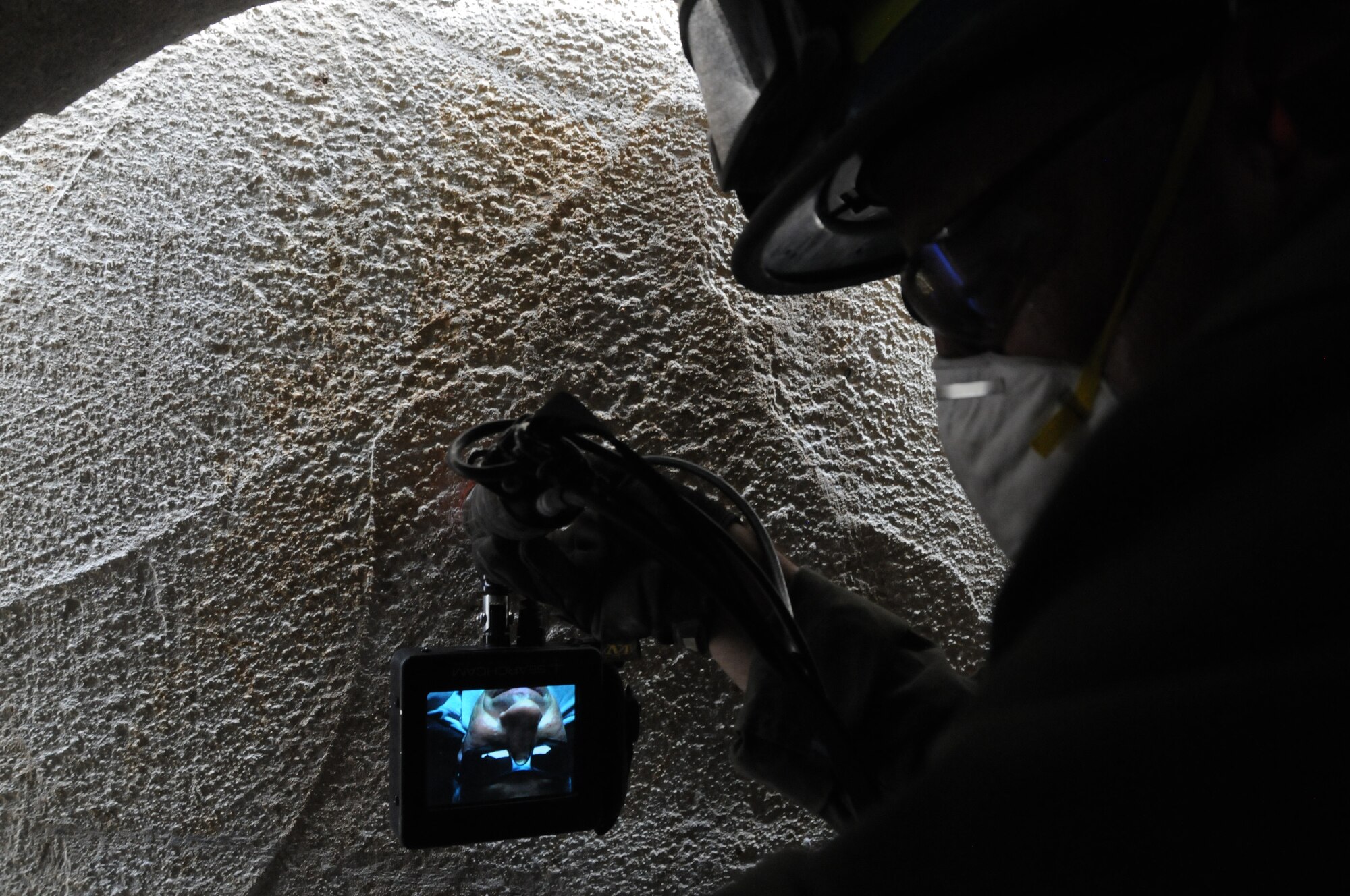 A 193rd Special Operations Wing firefighter views what is on the other side of a collapse structure during a Federal Emergency Management Agency Structural Collapse Technician course at Senator John J. Shumaker Public Safety Center, Harrisburg, Pa. Sept. 5, 2014. The two-week course prepared firefighters in the event that they are needed to preform Urban Search and Rescue missions. (U.S. Air National Guard photo by Tech. Sgt. Culeen Shaffer/Released)