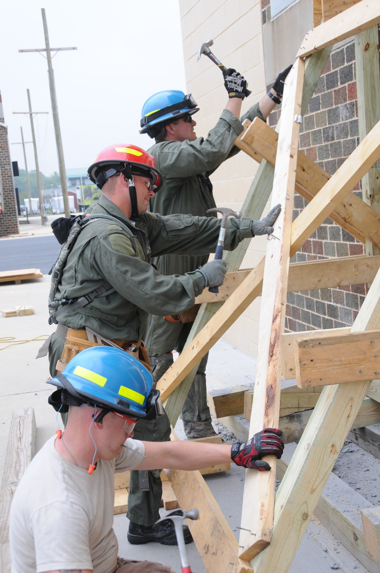 Staff Sgt. Jody Meade, bottom left, Tech. Sgt. Jeremy Weaver, and Master Sgt. Jesse Painter, 193rd Special Operations Wing firefighters build shoring during a Federal Emergency Management Agency Structural Collapse Technician course at Senator John J. Shumaker Public Safety Center, Harrisburg, Pa. Sept. 5, 2014. The two-week course prepared the firefighters in the event that they are needed to preform Urban Search and Rescue missions. (U.S. Air National Guard photo by Tech. Sgt. Culeen Shaffer/Released)