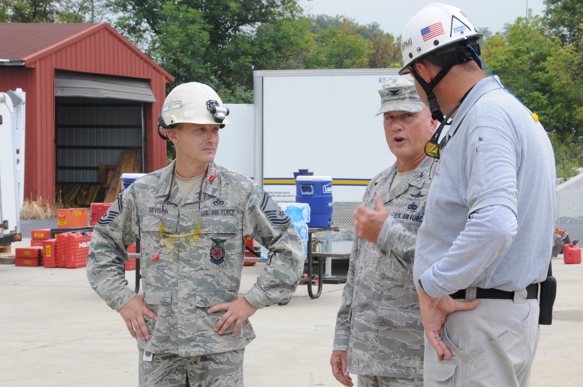 193rd Special Operations Mission Support Group Commander Col. Christopher Dutton, center, talks with Randy Padfield, right, the lead instructor at Senator John J. Shumaker Public Safety Center, Harrisburg, Pa. and Senior Master Sgt. Timothy Sevison, 193rd Special Operations Wing Fire Department superintendent about the Federal Emergency Management Agency Structural Collapse Technician course, Sept. 5, 2014. The two-week course prepared 193rd SOW firefighters in the event that they are needed to preform Urban Search and Rescue missions. (U.S. Air National Guard photo by Tech. Sgt. Culeen Shaffer/Released)