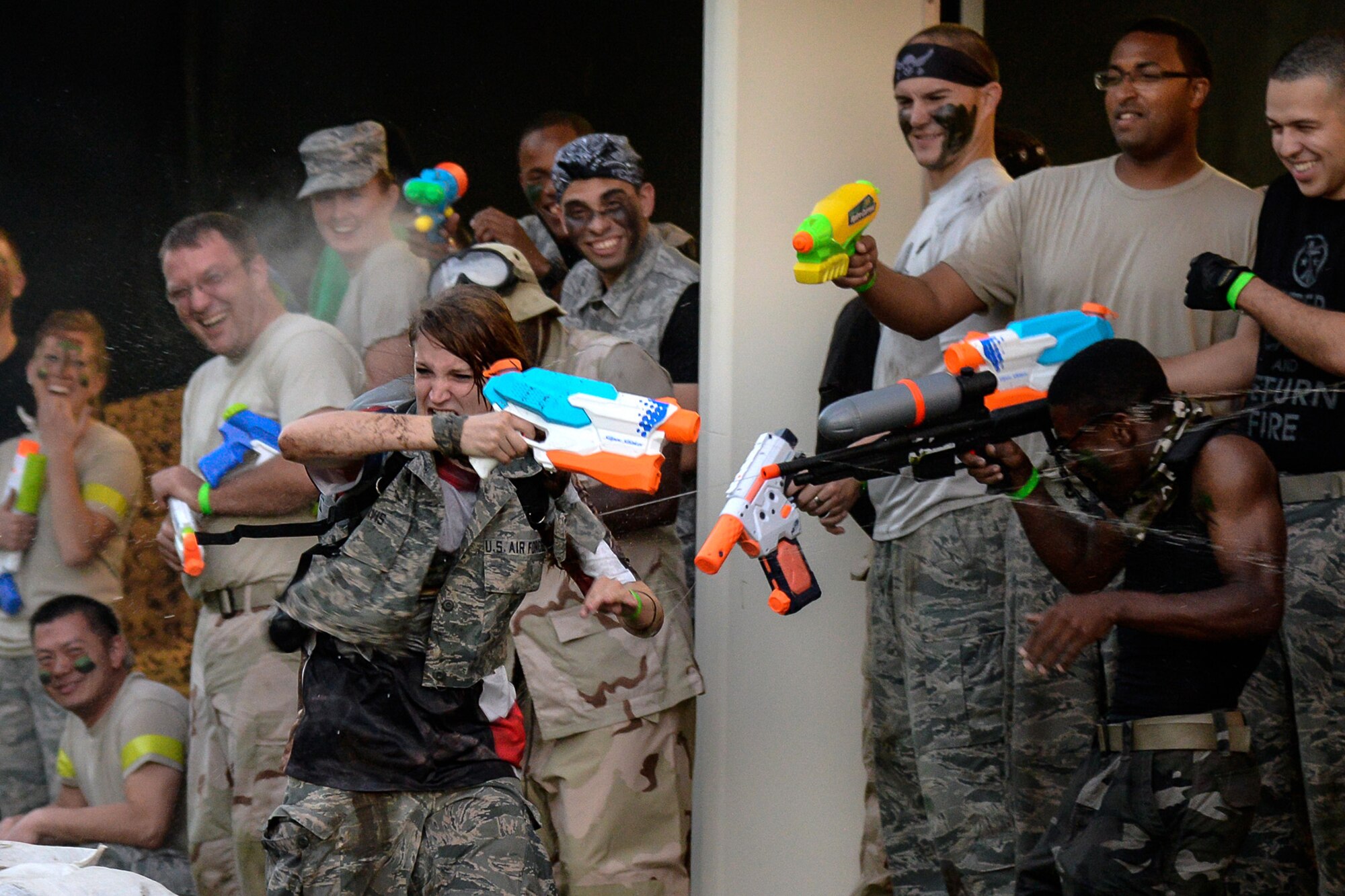 First Lt. Claire Davis, 66th Comptroller Squadron deputy budget officer, is showered with water from other military members after completing an obstacle course during the Hanscom Combat Dining In at the Tennis Bubble Sept. 26. In addition to the water fights, attendees enjoyed a catered meal and many other morale boosting activities. (U.S. Air Force photo by Walter Santos)
