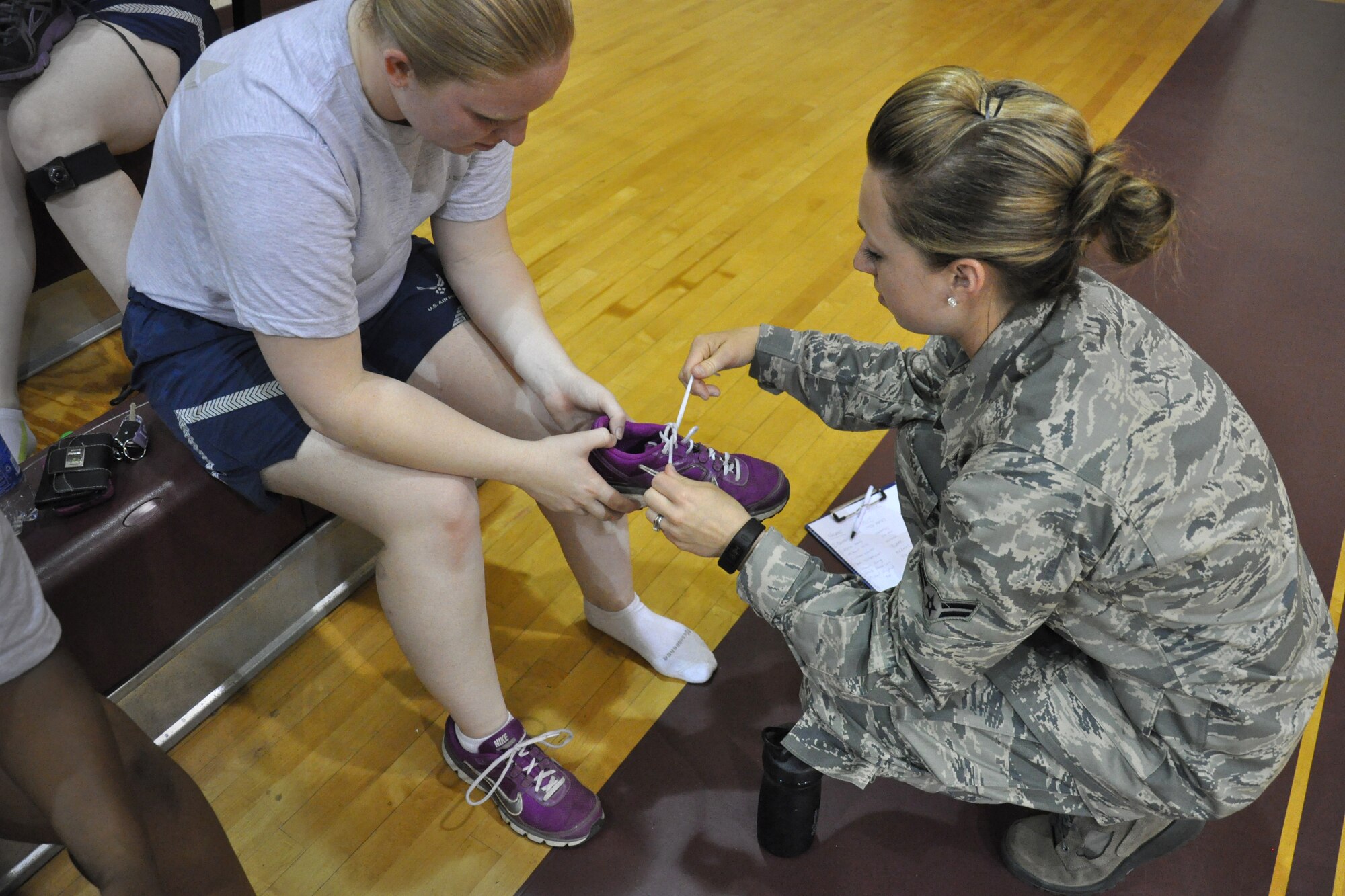 Airman 1st Class Rachel Patterson, 916th Force Support Squadron services specialist, provides a 916th Air Refueling Wing Airman with tips on proper shoe fit for fitness activities, Seymour Johnson Air Force Base, North Carolina. In addition to working as an Air Force Physical Training Leader, Patterson is an accredited, certified personal trainer and works full-time in the fitness industry. (Staff Sgt. Alan Abernethy) 