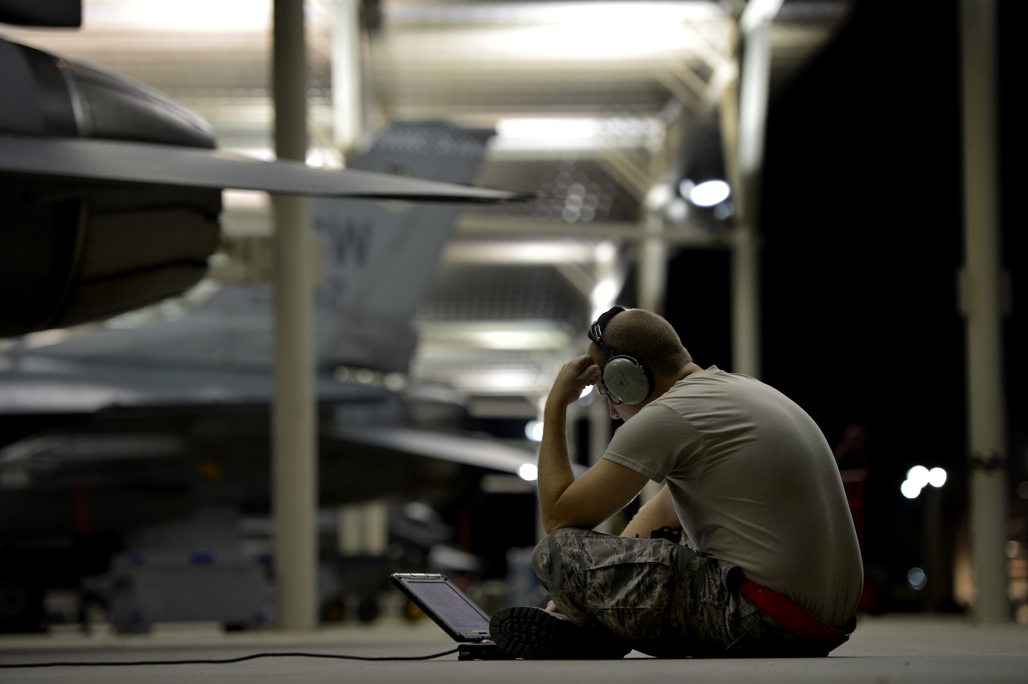 A U.S. Air Force aircraft maintainer assigned to the 20th Aircraft Maintenance Squadron, reviews aircraft data while working on an F-16CM Fighting Falcon with other maintainers at Shaw Air Force Base S.C., Sept. 18, 2014. The F-16CM is a single-seat, multi-mission fighter and is kept mission ready by 20th AMXS maintainers. (U.S. Air Force photo by Staff Sgt. Kenny Holston/Released)