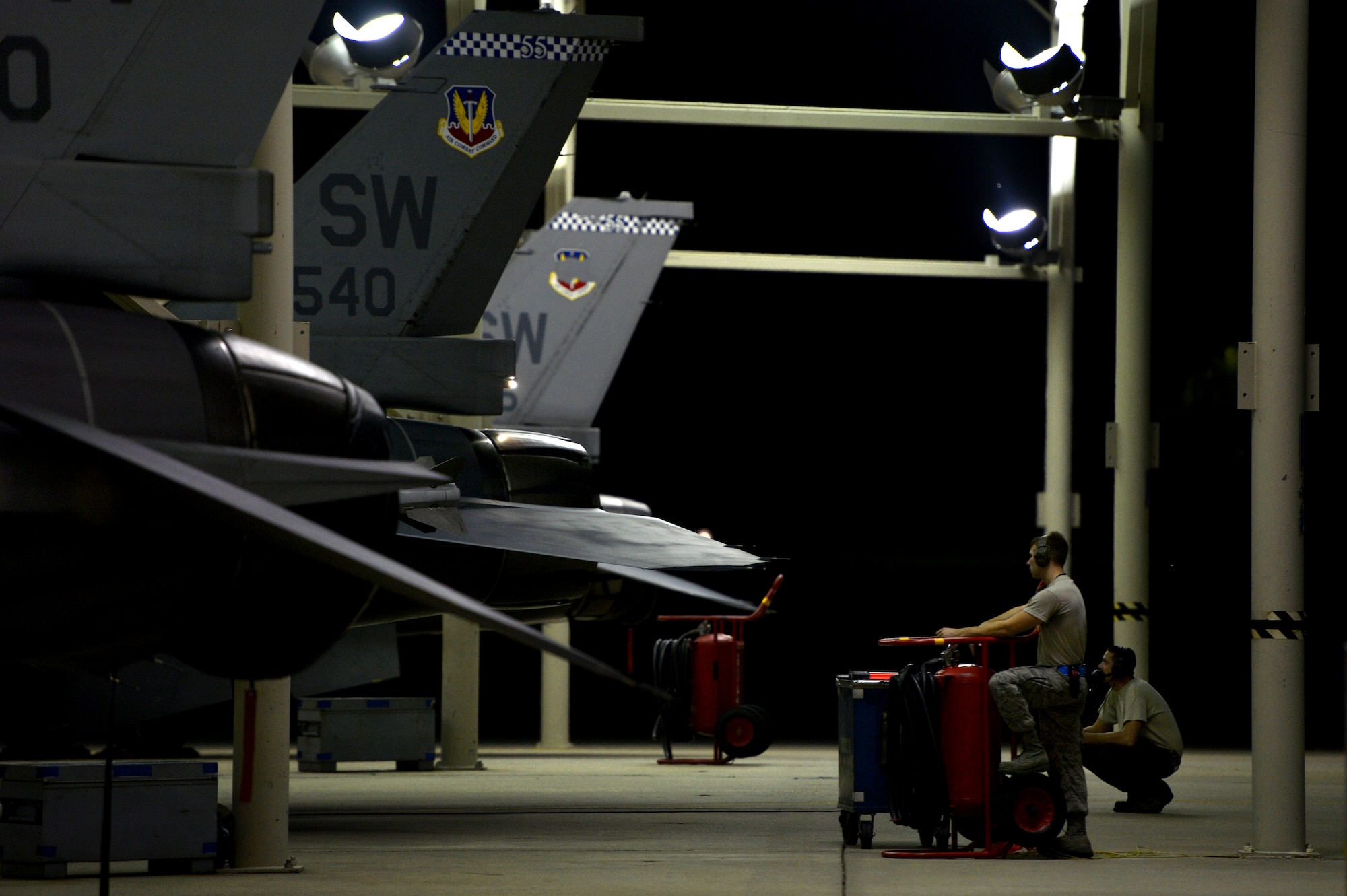 U.S. Air Force crew chiefs assigned to the 20th Aircraft Maintenance Squadron prepare to launch an F-16CM Fighting Falcon during night operations at Shaw Air Force Base, S.C., Sept. 18, 2014. As the primary maintainer of their assigned aircraft, dedicated crew chiefs perform a great deal of maintenance, and are also responsible for calling in specialists when needed, like avionics or propulsion technicians, in order to keep their aircraft ready for flight at all times. (U.S. Air Force photo by Staff Sgt. Kenny Holston/Released)