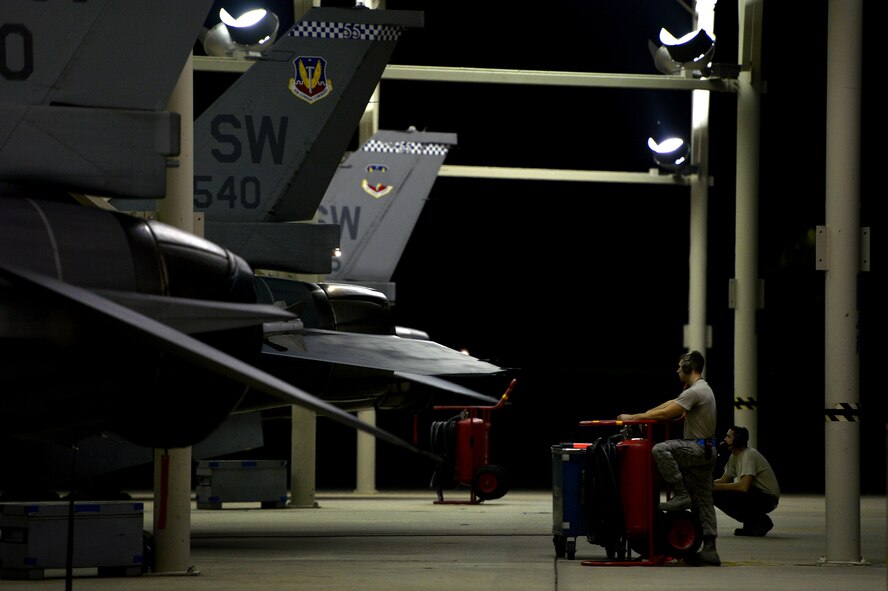 U.S. Air Force crew chiefs assigned to the 20th Aircraft Maintenance Squadron prepare to launch an F-16CM Fighting Falcon during night operations at Shaw Air Force Base, S.C., Sept. 18, 2014. As the primary maintainer of their assigned aircraft, dedicated crew chiefs perform a great deal of maintenance, and are also responsible for calling in specialists when needed, like avionics or propulsion technicians, in order to keep their aircraft ready for flight at all times. (U.S. Air Force photo by Staff Sgt. Kenny Holston/Released)