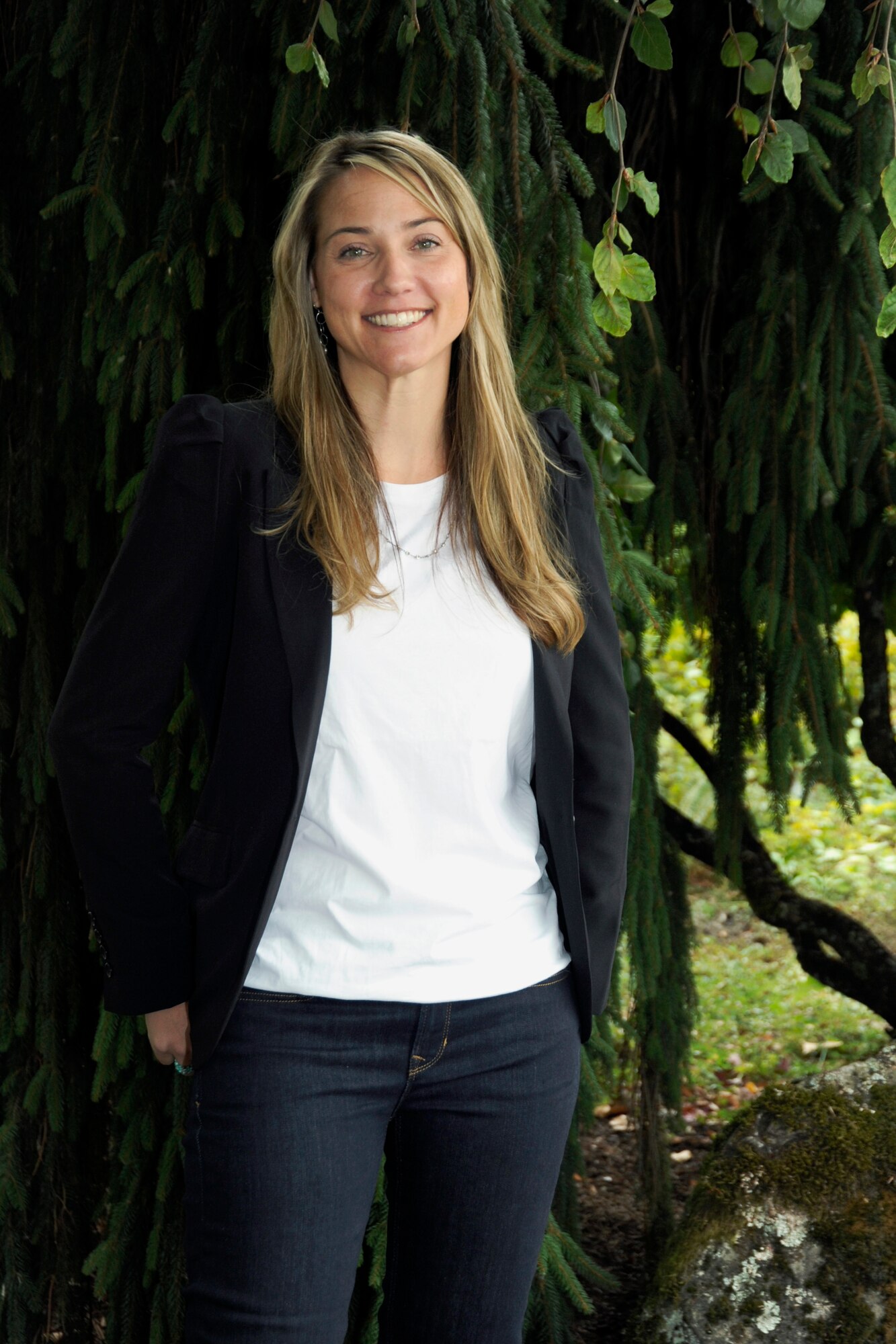 Amy Conroy, the new Family Programs Director for the 142nd Fighter Wing stands for a photograph outside the unit Headquarters building at the Portland Air National Guard Base, Ore., Sept. 23, 2014. Prior to being hired by the 142nd Fighter Wing, Conroy was the Lead Child & Youth Program Coordinator for the Oregon National Guard. (U.S. Air National Guard photo by Tech. Sgt. John Hughel, 142nd Fighter Wing Public Affairs/Released)