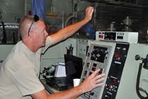 MOUNTAIN HOME AIR FORCE BASE, Idaho – Air Force Reserve Tech. Sgt.  Tom Kocis, an aerial spray maintainer assigned to the 910th Maintenance Squadron, uses the control panel of the Modular Aerial Spray System (MASS) to mix water, an herbicide product and an anti-drift material in the MASS tanks onboard a C-130 Hercules aircraft prior to its take off here, Sept. 18, 2014.  The aircraft performed a series of aerial spray sorties using the mixture over the nearby Saylor Creek Bombing Range. The 910th Airlift Wing, based at Youngstown Air Reserve Station, Ohio, is home to the Department of Defense’s only large-area, fixed-wing aerial spray capability, conducted a mission to spray herbicide on invasive cheat grass as a means of fire prevention here, Sept. 15-26, 2014. U.S. Air Force photo by Master Sgt. Bob Barko Jr.