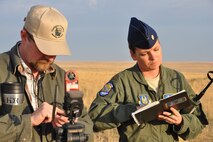 MOUNTAIN HOME AIR FORCE BASE, Idaho – Mr. Carl Rudeen, the natural resource manager assigned to the 366th Civil Engineer Office at Mountain Home AFB, and Air Force Reserve Maj. Jen Remmers, an entomologist assigned to the 910th Airlift Wing’s 757th Airlift Squadron, check and record the ground wind speed on the Saylor Creek Range here, Sept. 17, 2014. The wind speed check is to ensure conditions are within acceptable parameters for an aerial spray sortie to be conducted by the aircrew of a C-130H Hercules assigned to the 910th Airlift Wing. The wing, based at Youngstown Air Reserve Station, Ohio, is home to the Department of Defense’s only large-area, fixed-wing aerial spray capability, conducted a mission to spray herbicide on invasive cheat grass as a means of fire prevention here, Sept. 15-26, 2014. U.S. Air Force photo by Master Sgt. Bob Barko Jr.