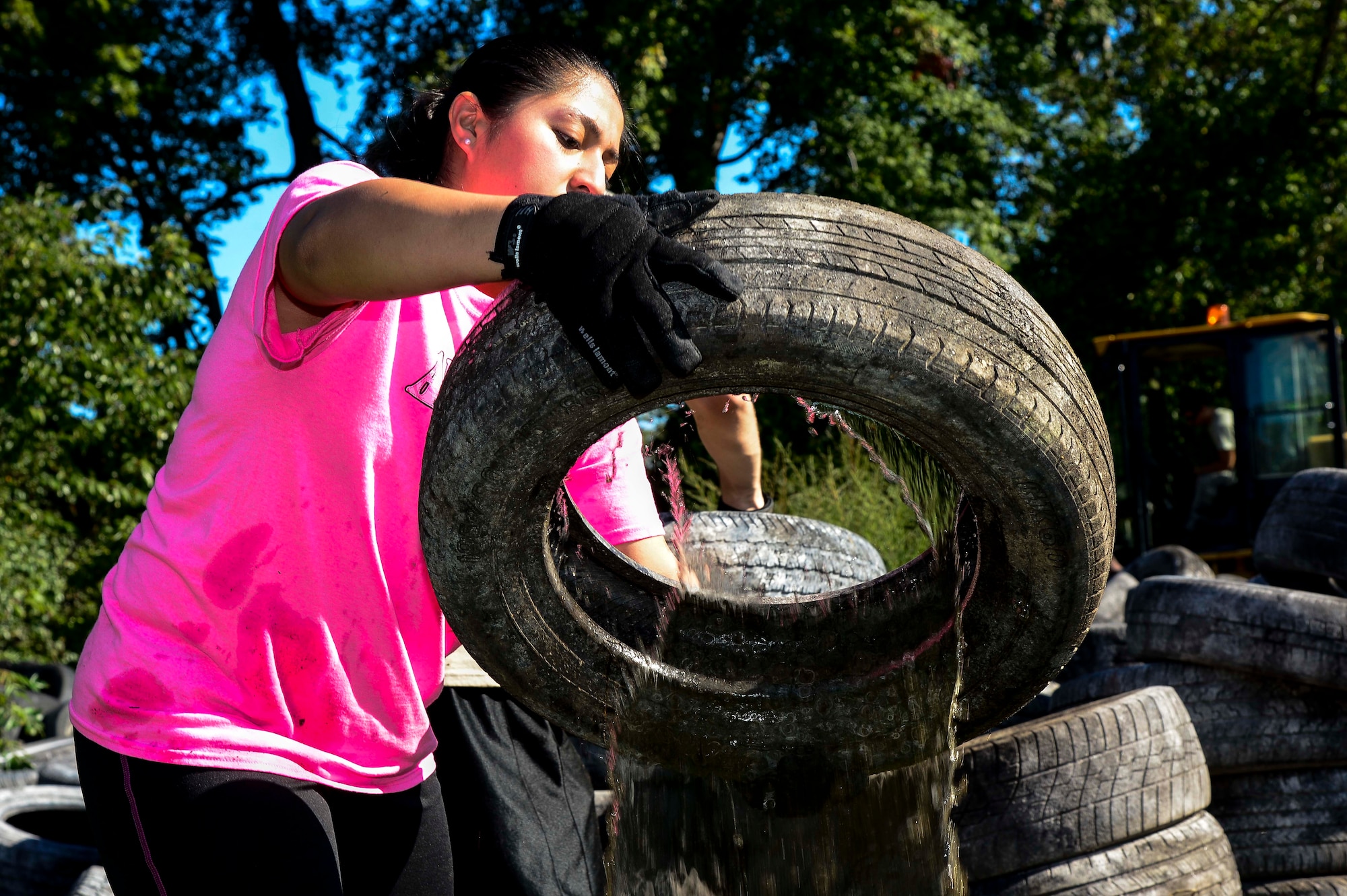 U.S. Air Force Staff Sgt. Elizabeth Townsend-Saeteros, Air Combat Command protocol specialist, helps remove unclaimed tires during a restoration project in Hampton, Va., Sept. 27, 2014. The Bethel Park and Family Campground underwent restoration after the 633rd Civil Engineer Squadron was awarded a National Public Lands Day Legacy grant of $6,212. (U.S. Air Force photo by Senior Airman Kayla Newman/Released)