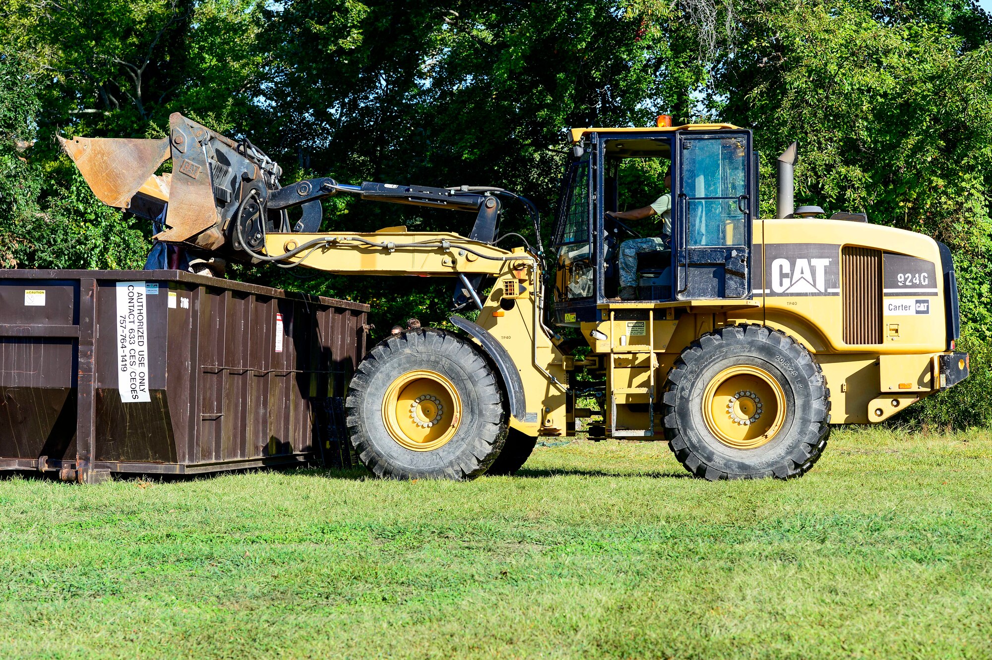 A U.S. Air Force Airman assigned to the 633rd Civil Engineer Squadron clears debris during a restoration project in Hampton, Va., Sept. 27, 2014. Airmen, members of the Hampton Master Gardeners Association, local Boy Scout troops and members of the Hampton Historical Society were all part of the approximately 30 volunteers who restored the Bethel Park and Family Campground. (U.S. Air Force photo by Senior Airman Kayla Newman/Released) 