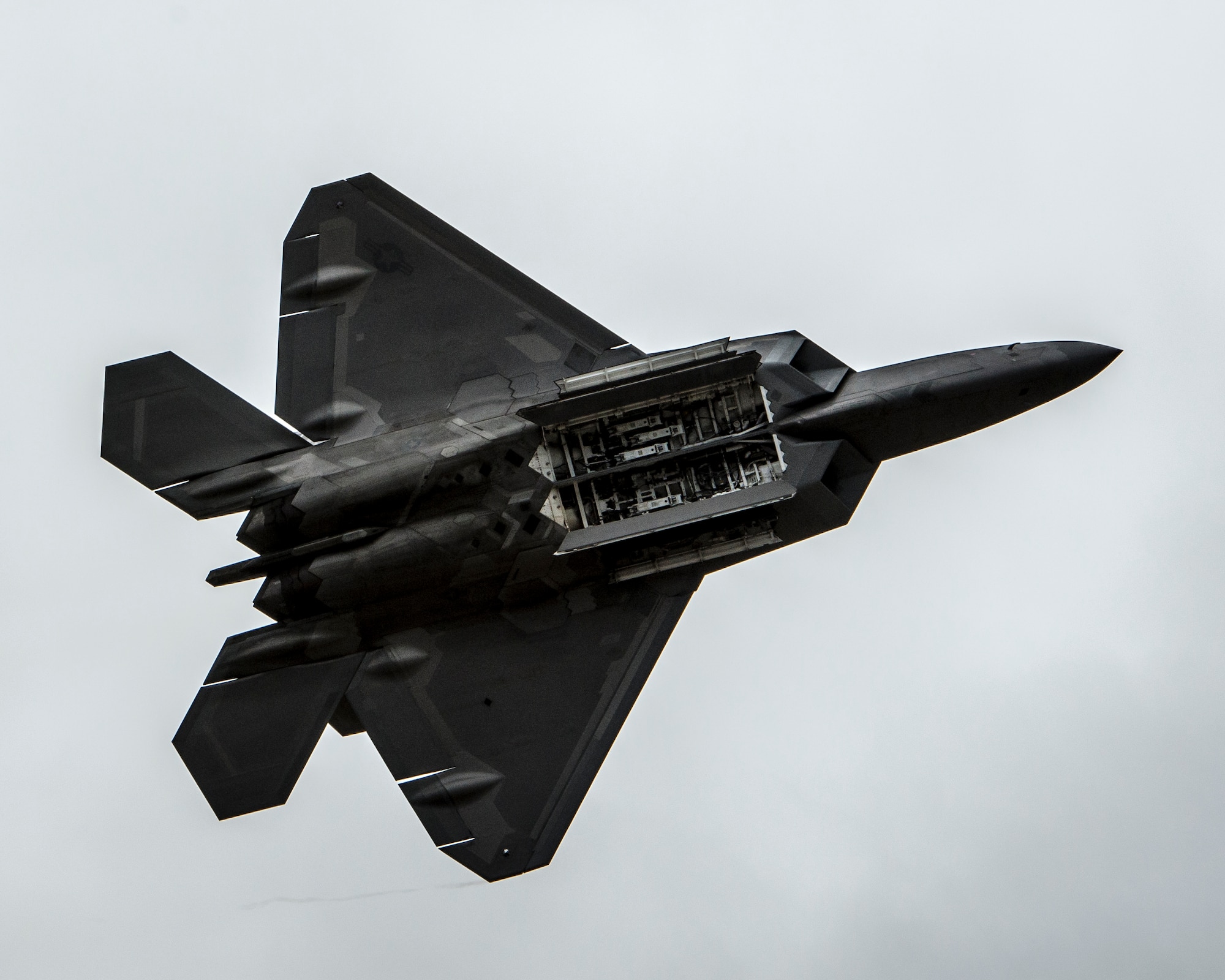 An F-22 Raptor displays its internal weapons bay during the Wings over the Pacific Air Show at Joint Base Pearl Harbor-Hickam, Hawaii, Sept. 28, 2014. Advances in low-observable technologies provide the Raptor significantly improved survivability and lethality against air-to-air and surface-to-air threats. (U.S. Air Force photo by Capt. Raymond Geoffroy/Released)