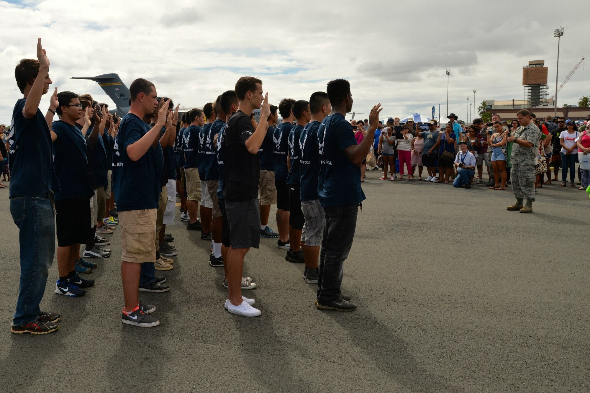 U.S. Air Force recruits recite the U.S. Armed Forces Oath of Enlistment during the Wings Over the Pacific Air Show at Joint Base Pearl Harbor-Hickam, Hawaii, Sept. 28, 2014. Members of the 369th Air Force Recruiting Squadron organized and executed the presentation as a unique way for future Airmen to recite the Oath. (U.S. Air Force photo by Staff Sgt. Alexander Martinez/Released)