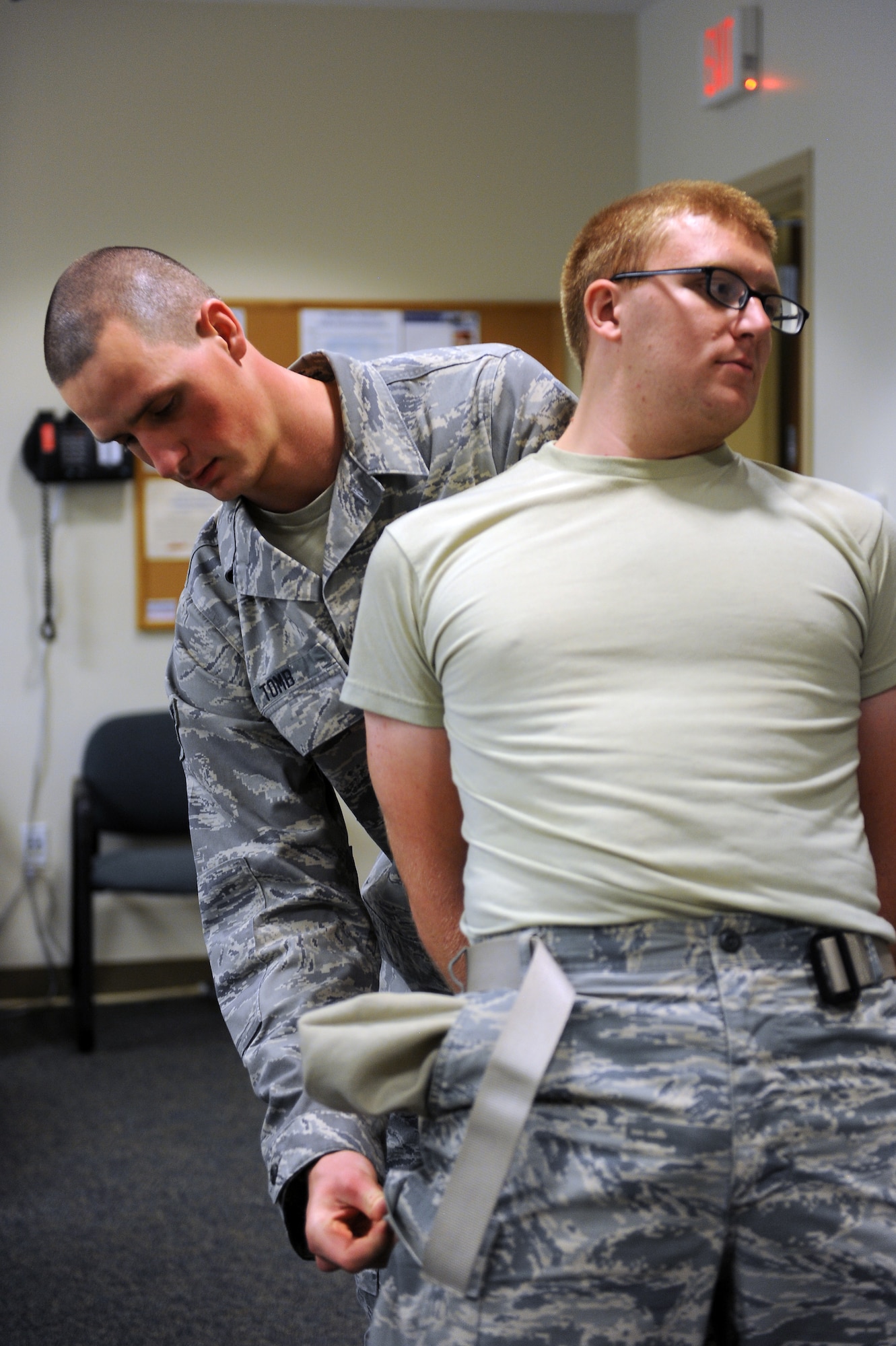 Airman 1st Class Seth Tomb, 375th Communications Squadron, searches A1C Joseph Wood, 375th Communications Support Squadron, during a training session Sept. 24, 2014 at Scott Air Force Base, Ill. This was part of the 375th Security Forces Squadron augmentee training program which prepares non security forces members to assist during periods of low manning. (U.S. Air Force photo/Staff Sgt. Jonathan Fowler)