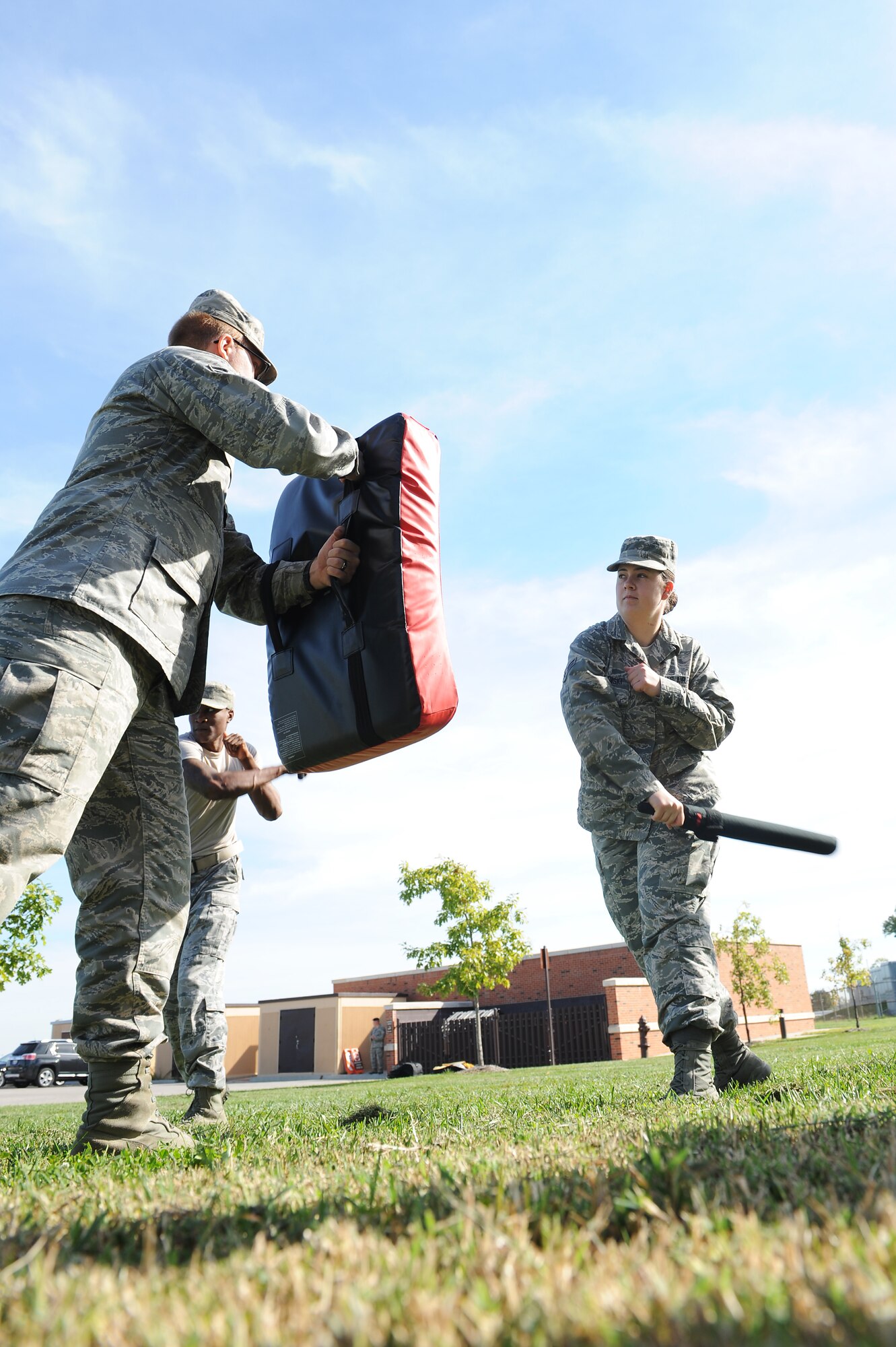 Airman 1st Class Samantha Maslowski, 375th Communications Squadron, swings at a pad during a training session Sept. 24, 2014 at Scott Air Force, Ill. Maslowski is one of many 375th Security Forces Squadron augmentees, who are pulled from other organizations to assist SF due to low manning. (U.S. Air Force photo/Staff Sgt. Jonathan Fowler)