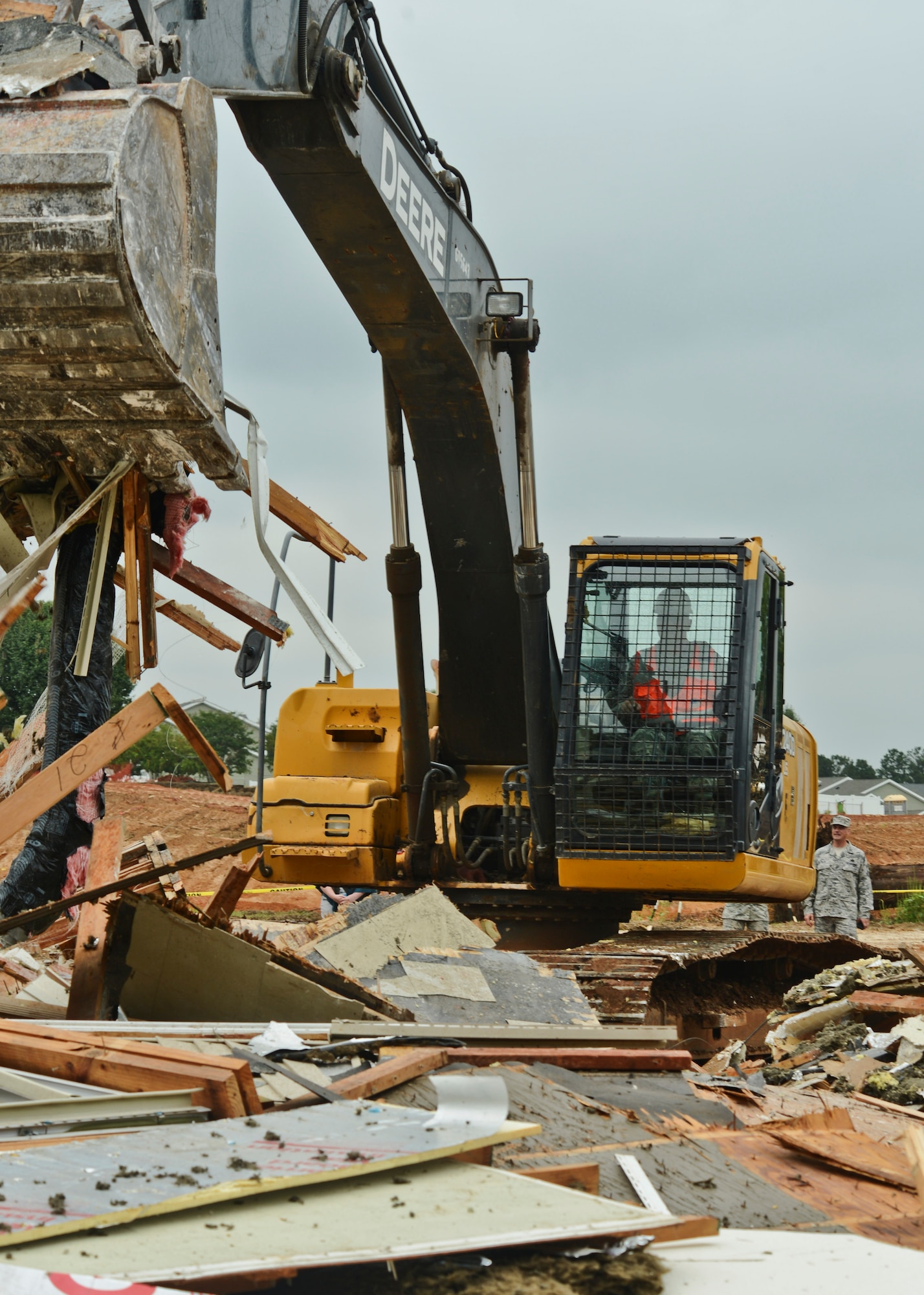 U.S. Air Force Chief Master Sgt. Charles Mills, 20th Fighter Wing command chief, moves debris during the junior NCO base housing demolition at Shaw Air Force Base, S.C., Sept. 15, 2014. The structure that was cleared will permit the construction of the remaining 182 enlisted rank homes. (U.S. Air Force photo by Senior Airman Tabatha Zarrella/Released)