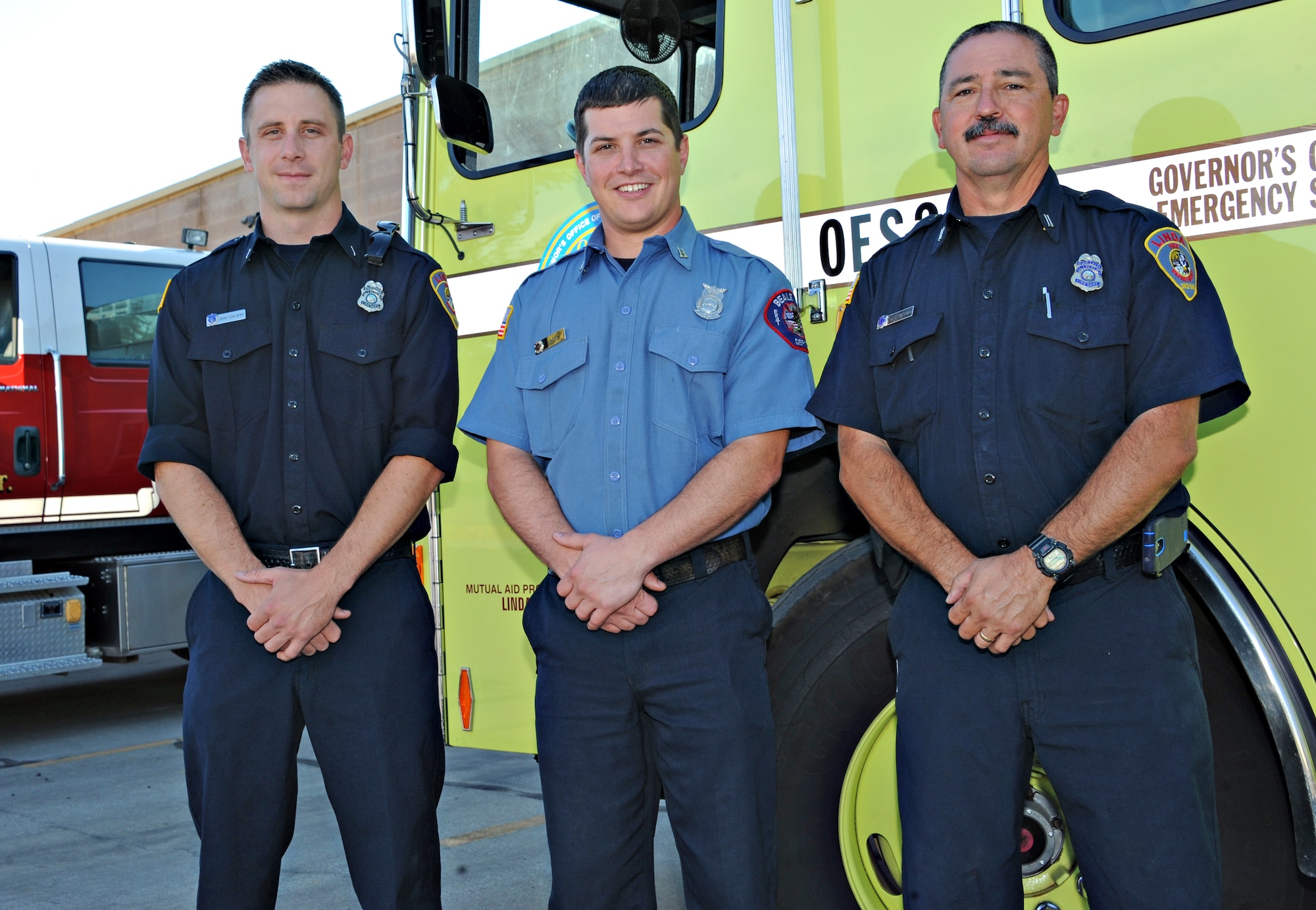 (From left to right)Josh Childers, Linda Fire Department engineer, Fire Captain William Hock, 9th Civil Engineer Squadron lead firefighter, and Captain Dave Gothrow, Linda Fire Department firefighter, pose in front of a California Governor's Office of Emergency Services fire engine Sept. 23, 2014, in Linda, Calif. The three firefighters responded to a request from the California Governor’s Office of Emergency Services to assist with Northern California’s Gulch Fire in Shasta County and the Boles Fire in the city of Weed.  (U.S. Air Force photo by Airman 1st Class Ramon A. Adelan/Released)