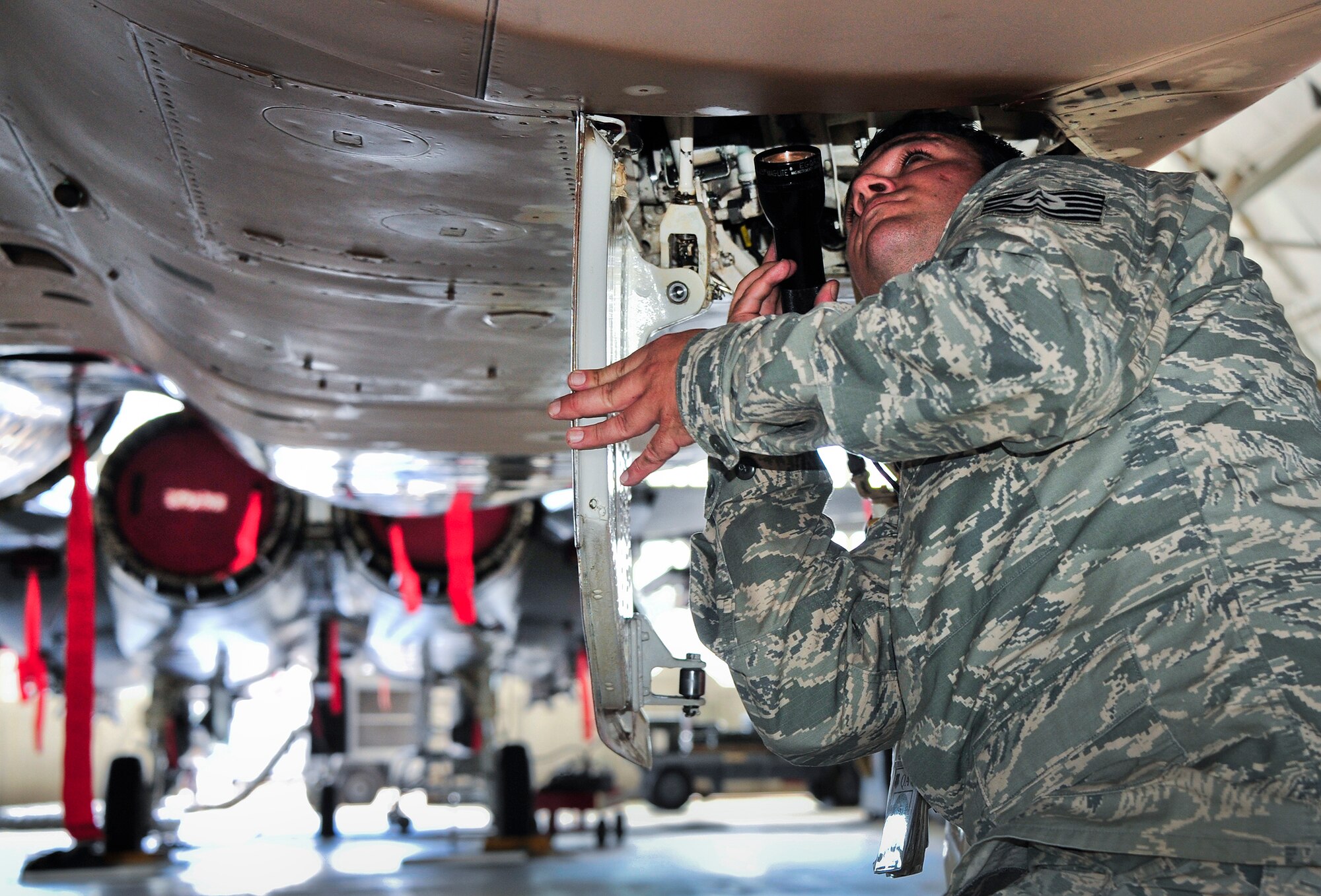 Tech. Sgt. Jeremy Lowery inspects the left main landing gear wheel well of an F-15 Eagle Sept. 26 following 96th Maintenance Group competition events at Eglin Air Force Base, Fla. Quality assurance personnel like Lowery participate with every weapons load and dedicated crew chief competitions as inspectors. They inspect the aircraft, boxes, aircraft forms and look for discrepancies. The chief inspector will brief the chiefs and senior leadership within maintenance units of their findings, if any, and tally up the scores to determine the winners. (U.S. Air Force Photo/Ilka Cole)
