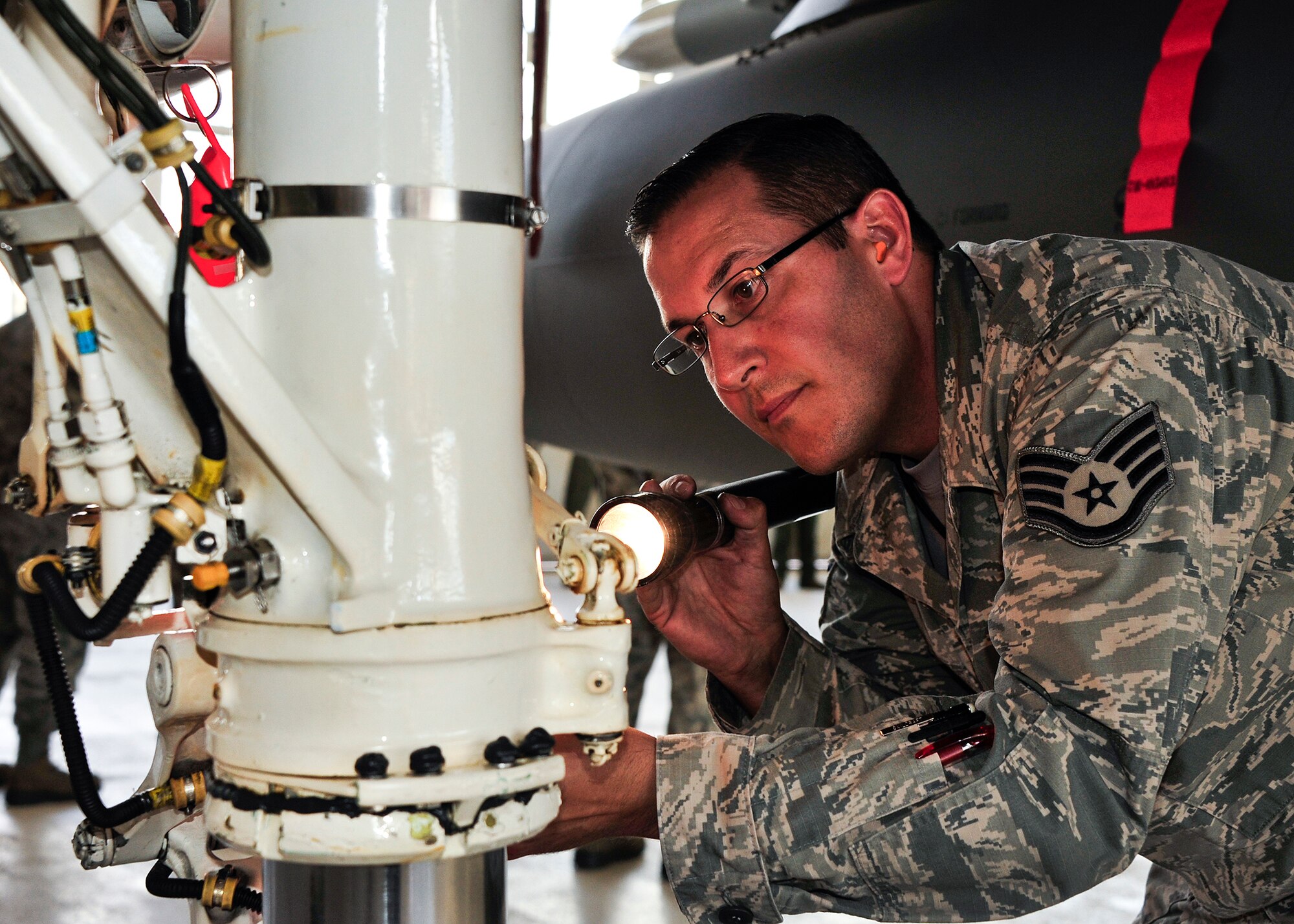 Staff Sgt. Matthew Murphy, inspects the right main landing gear shock strut of an F-15 Eagle Sept. 26 following 96th Maintenance Group competition events at Eglin Air Force Base, Fla. Quality assurance personnel like Murphy participate with every weapons load and dedicated crew chief competitions as inspectors. They inspect the aircraft, boxes, aircraft forms and look for discrepancies. The chief inspector will brief the chiefs and senior leadership within maintenance units of their findings, if any, and tally up the scores to determine the winners. (U.S. Air Force Photo/Ilka Cole)