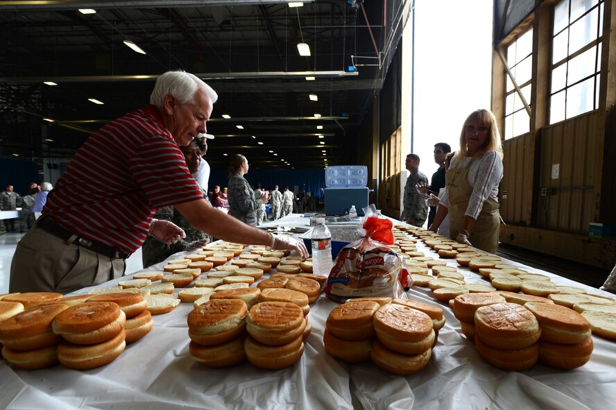 Hamburger buns are lined up by Sumter community volunteers during the Military Appreciation Picnic inside Hangar 1200 at Shaw Air Force Base, S.C., Sept. 26, 2014. Approximately 1,200 hamburgers were prepared for service members to enjoy during the event. (U.S. Air Force photo by Airman 1st Class Jensen Stidham/Released)