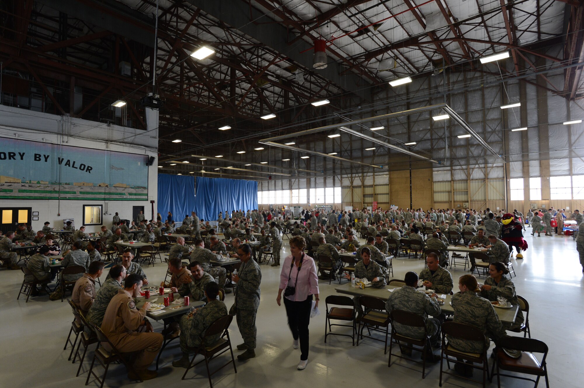 Team Shaw members eat lunch during the 6th Annual Military Appreciation Picnic inside Hangar 1200 at Shaw Air Force Base, S.C., Sept. 26, 2014. Hosted by the Greater Sumter Chamber of Commerce, the event was held for the community to show appreciation to the men and women assigned to Shaw. (U.S. Air Force photo by Airman 1st Class Jensen Stidham/Released) 