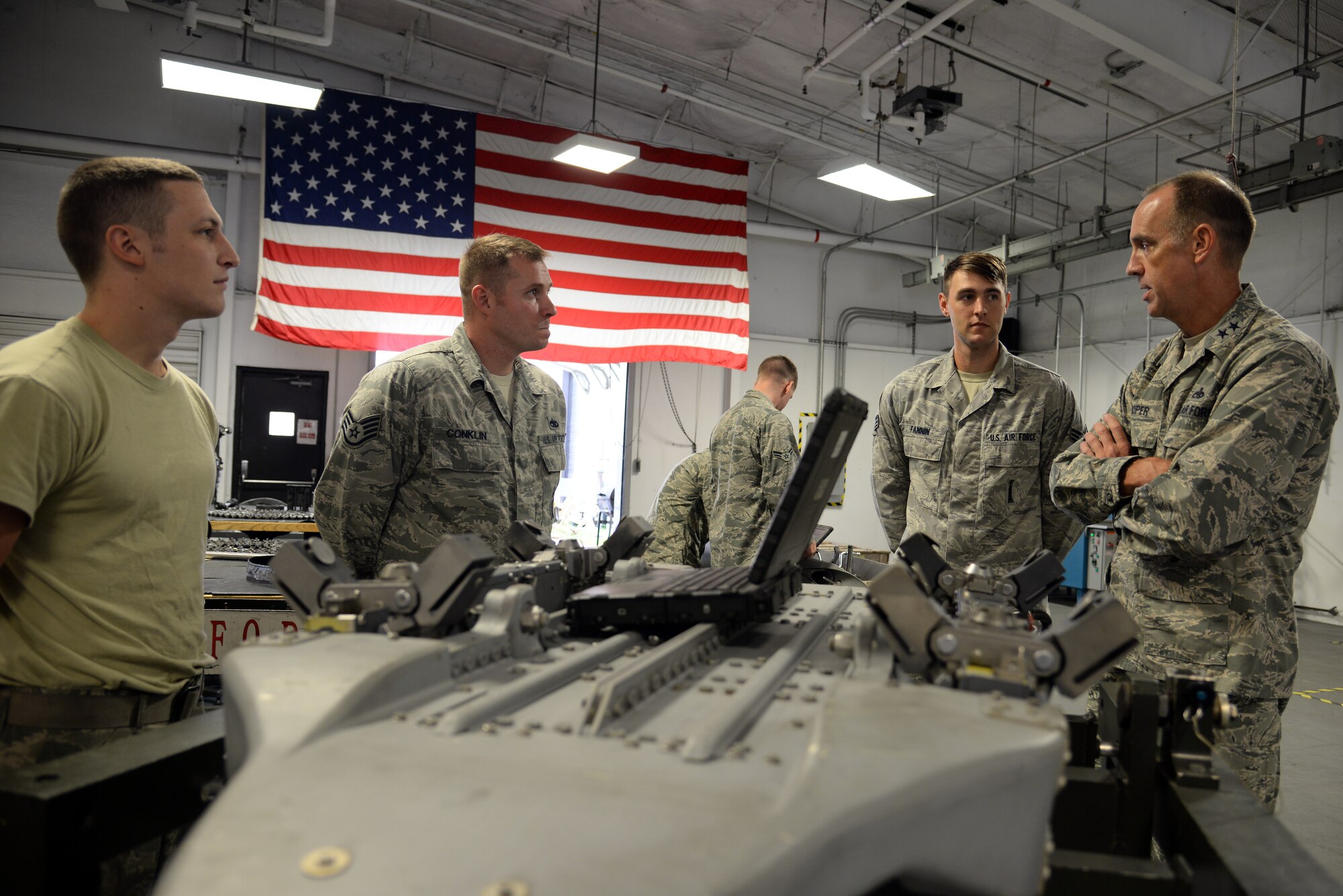 U.S. Air Force Maj. Gen. John Cooper, Air Combat Command director of logistics (right), talks to Airmen assigned to the 20th Equipment Maintenance Squadron armament flight, about their work at Shaw Air Force Base, S.C., on Sept. 25, 2014. The armament flight recently renovated inspection processes for the 20mm Gatling gun that the F-16CM Fighting Falcon uses. (U.S. Air Force photo by Airman 1st Class Jonathan Bass/Released)